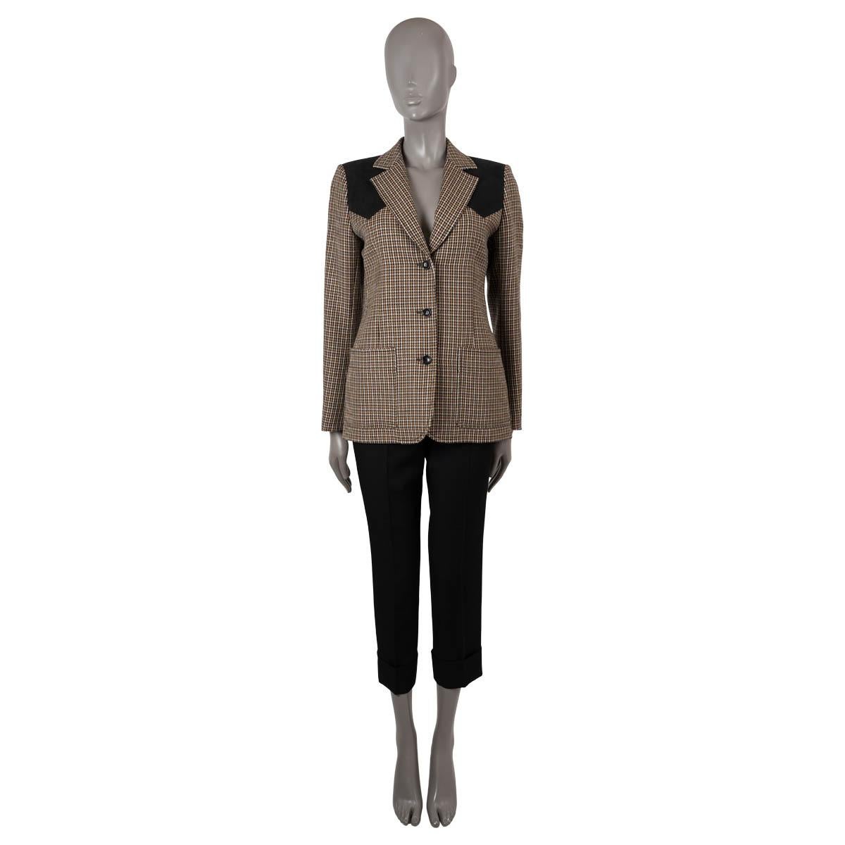 100% authentic Louis Vuitton blazer in beige, cream, black and chocolate brown wool (100%). Features black suede shoulder panels, notched lapels and patch pockets at the waist. Closes with three buttons and is lined in viscose (50%) and cupro (50%).