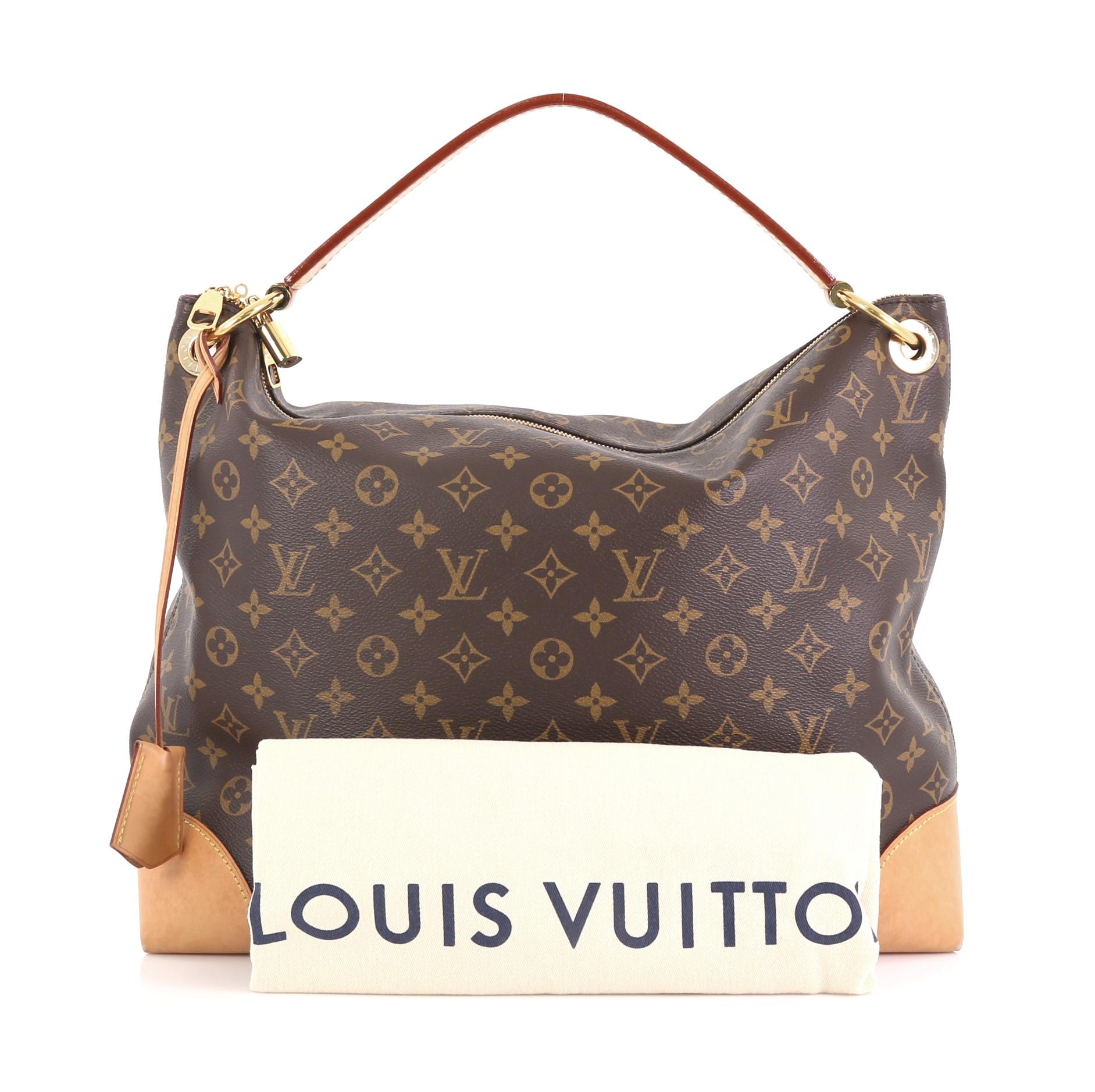This Louis Vuitton Berri Handbag Monogram Canvas MM, crafted from brown monogram coated canvas, features a looping leather handle, cowhide leather corners, and gold-tone hardware. Its two-way zip closure opens to a purple fabric interior with slip