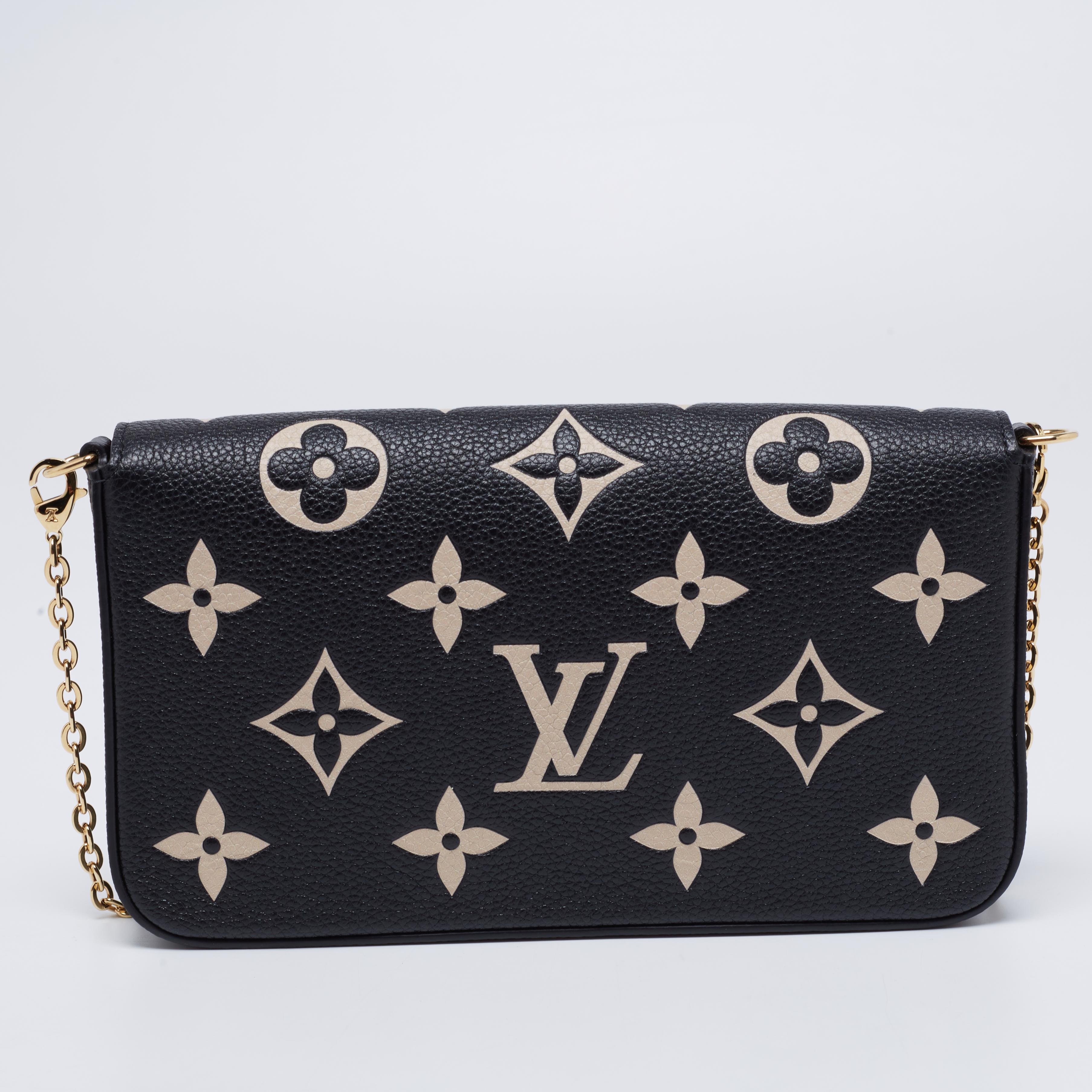 You know you're going to catch admiring glances when you swing this luxe pochette by Louis Vuitton. It has been crafted from leather and is enhanced with gold-tone hardware. The cute compact piece is bicolored and opens to reveal a fabric interior
