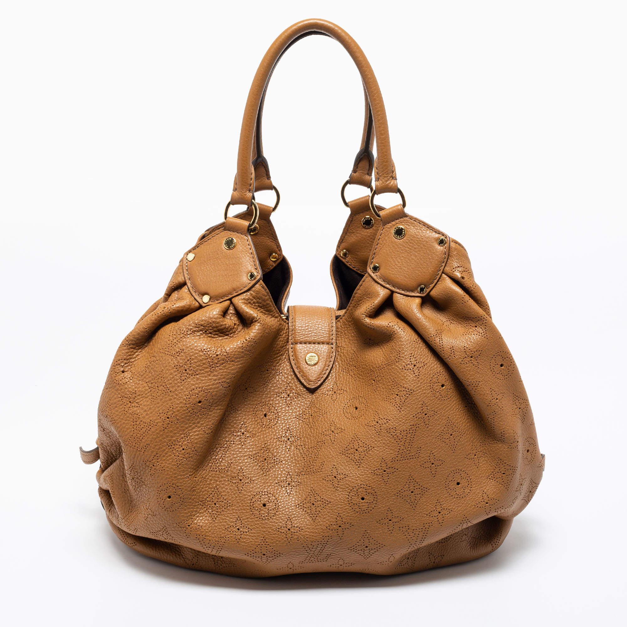 This Louis Vuitton bag is designed exquisitely. Its glossy body is inspired by the Hindu Sun God, Surya. Feminine and chic, it is roomy and perfect for everyday use. Crafted from intricately perforated Monogram patent leather, it features top
