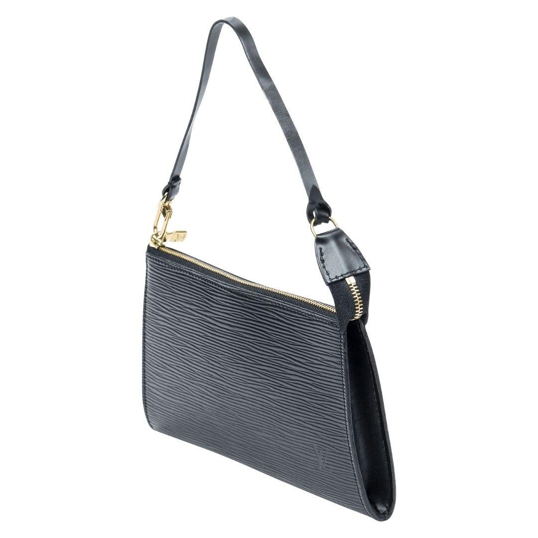The 1997 classic black Epi leather pochette from Louis Vuitton is the epitome of timeless style, featuring a silver-tone zipper and a soft alcantara lining for a touch of luxury.

SPECIFICS
Length: 8.5