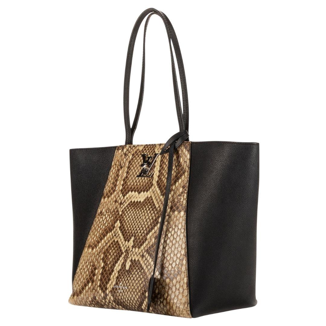 A sophisticated black tote by Louis Vuitton, combining python and calfskin. The silver-tone turn-lock opens to an alcantara interior with three well-organized pockets.

SPECIFICS
Length: 11.0
