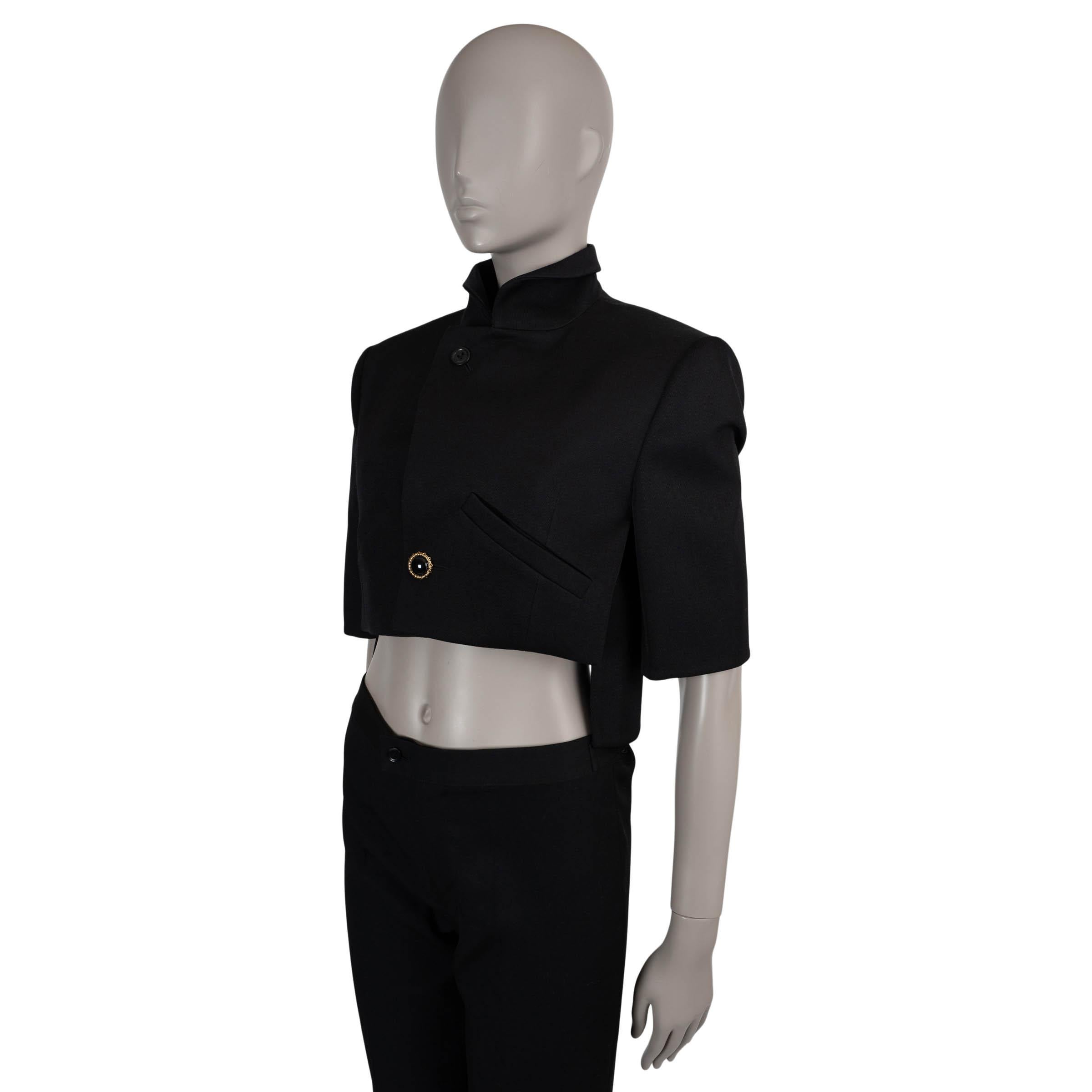 This 100% authentic Louis Vuitton jacket in black twill wool (100%) showcases architectural tailoring with a modern edge. Designed with a boxy, cropped silhouette and elongated sides, it features a high neck, short sleeves, and two functional