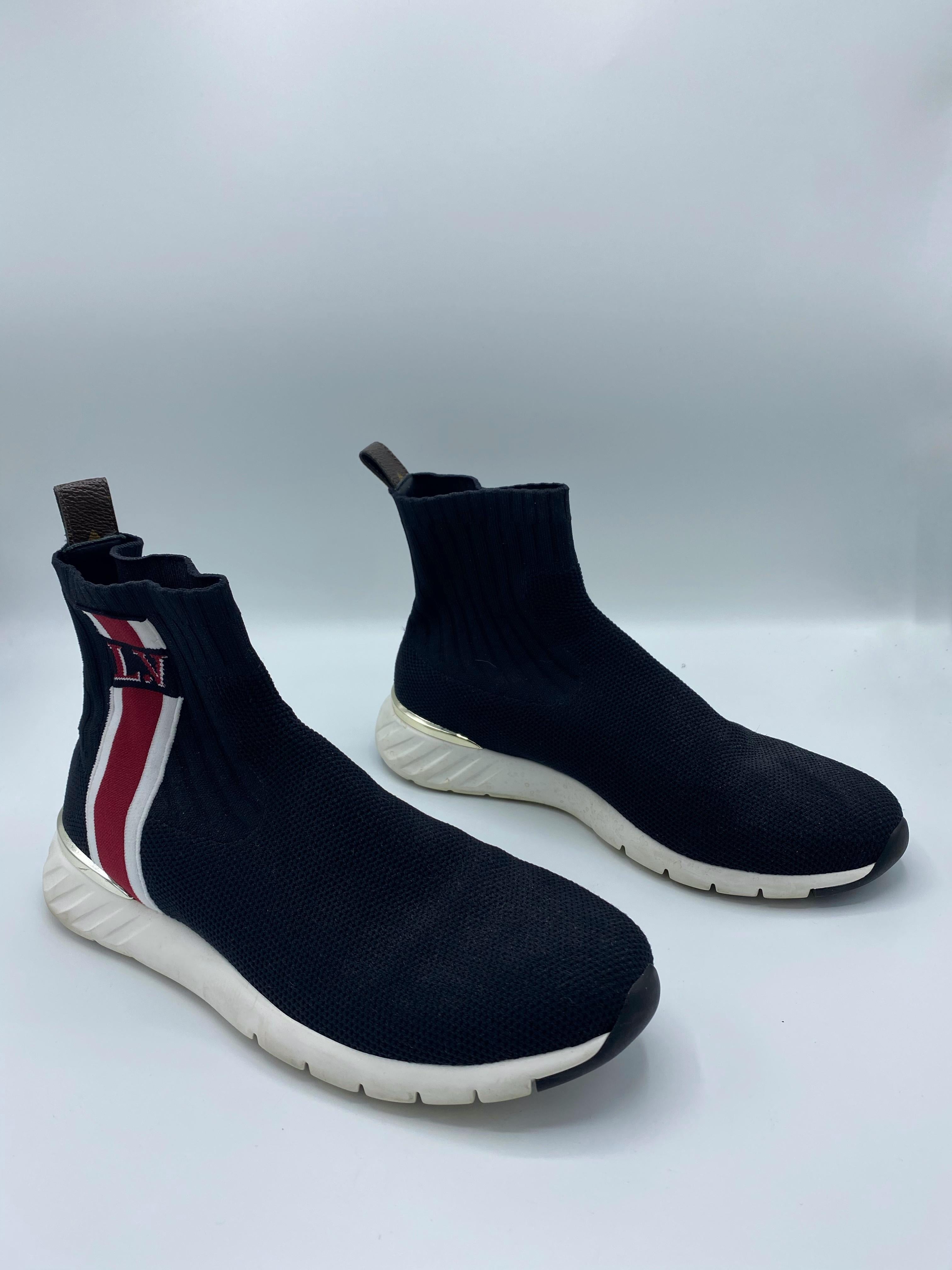 Product details: 

The sneakers made of black embroidered fabric and feature a red and white striping with the LV logo and white rubber soles. Made in Italy.