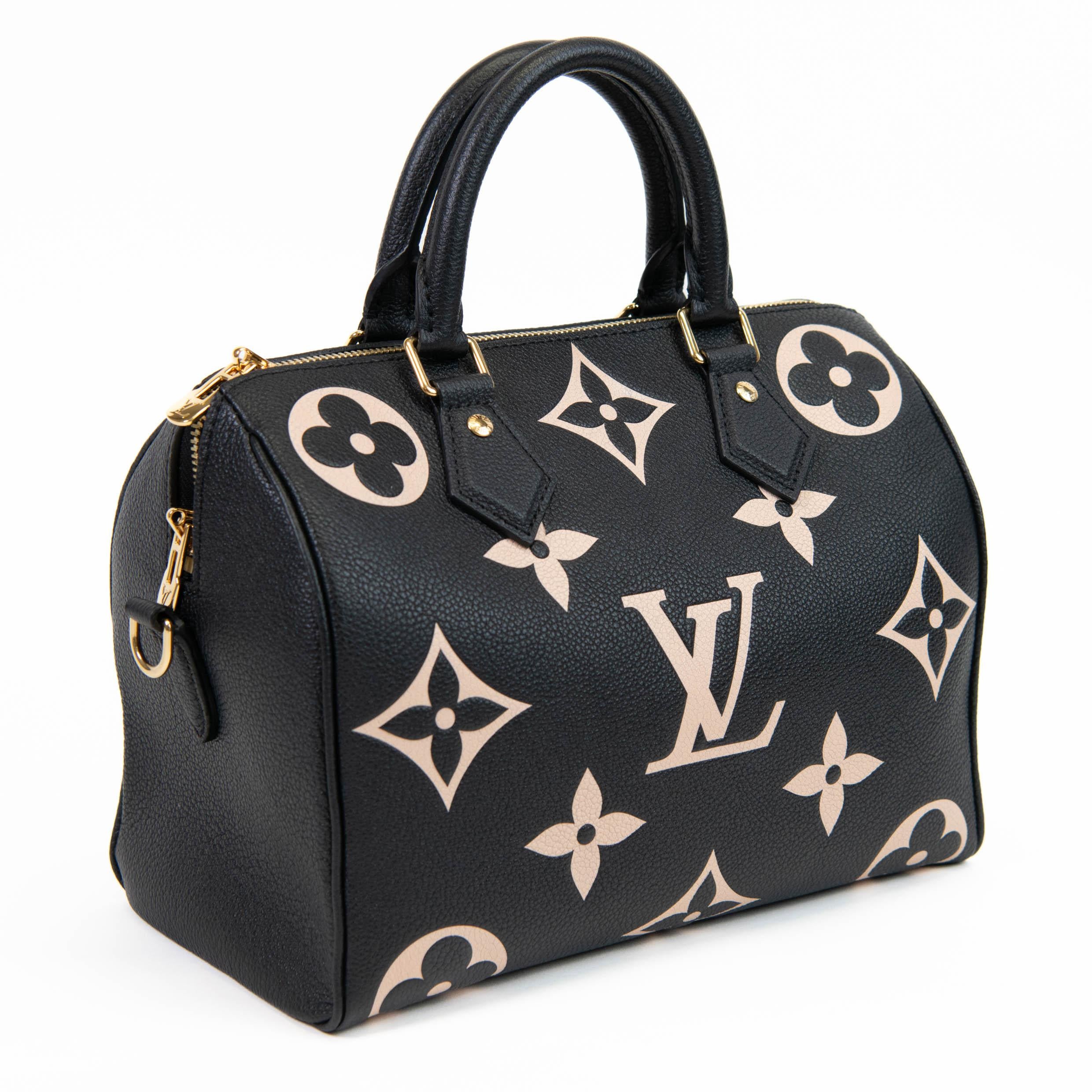100% Authentic

This classic tote is crafted of textured leather in black with an oversized monogram embossed in beige. The handbag features black top handles, an optional leather shoulder strap, and gold hardware. The top zipper opens to a burgundy