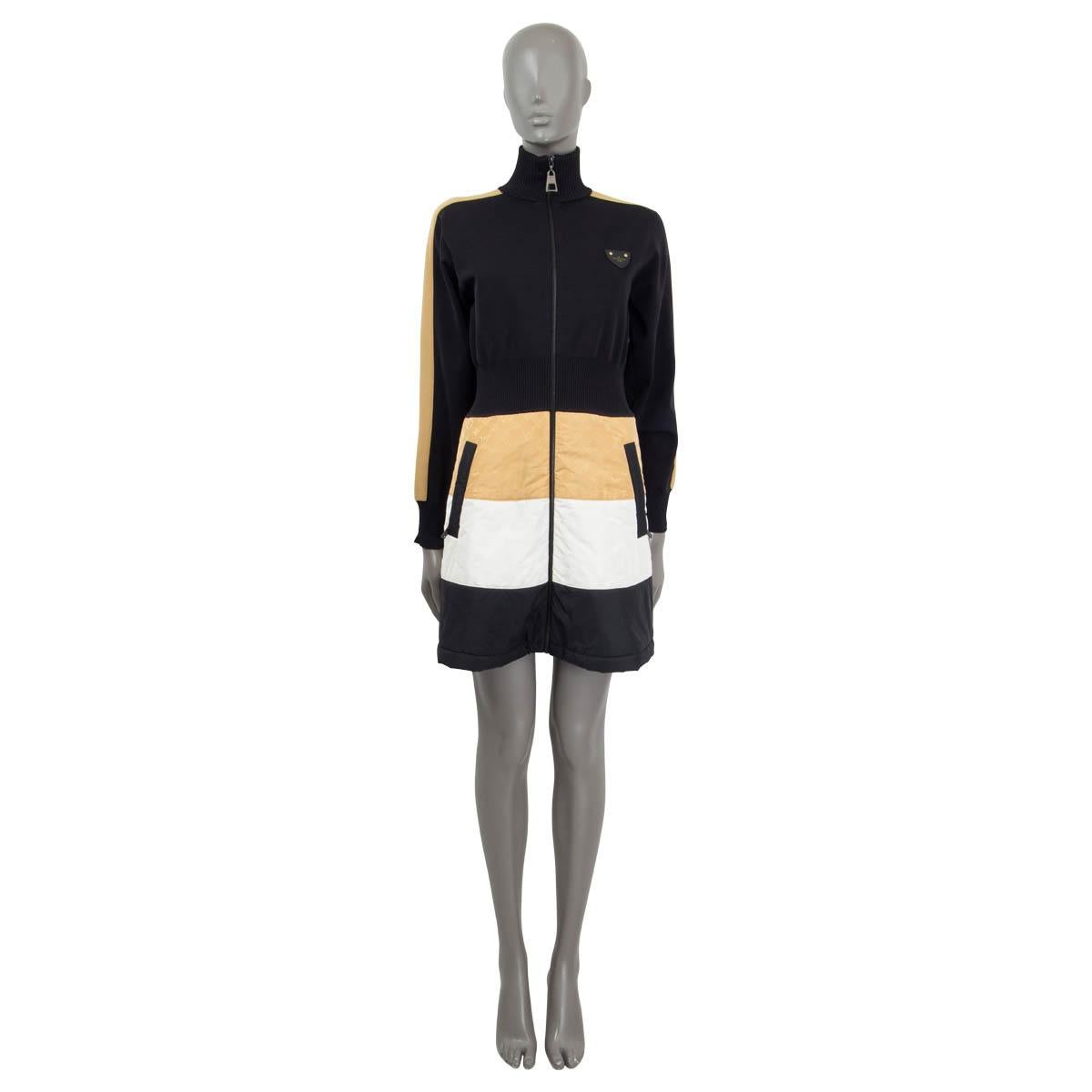100% authentic Louis Vuitton bi-material dress with a knit top in black polyamide (100%) and a technical fabric skirt in matte black, white and honey monogram taffeta (60% polyamide, 24% polyester and 16% silk). Features long raglan sleeves (sleeve
