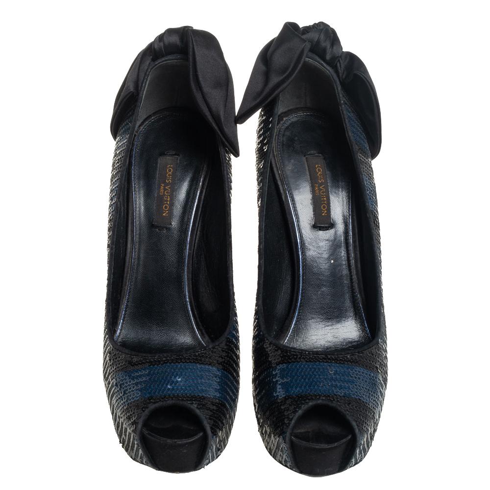 Perfect for all seasons, this pair of Louis Vuitton pumps are just what you need. These pumps are crafted in Italy and embellished with blue-black sequins that add a touch of glamour. They are styled with peep toes, platforms, 14 cm heels, and