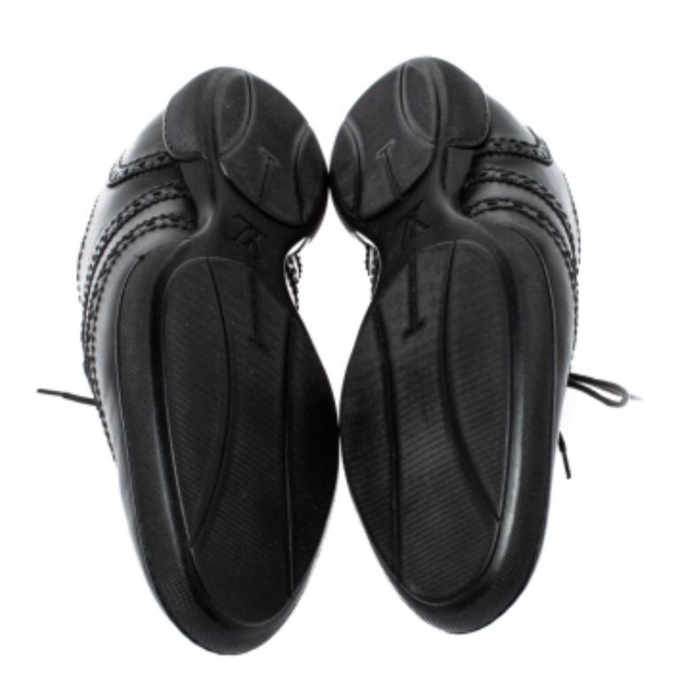 This pair of sneakers from Louis Vuitton speaks versatility in an effortless way. Crafted from quality leather, they've been designed with lace-ups at the vamp and accented with a wingtip and brogue details around the black expanse. This is one