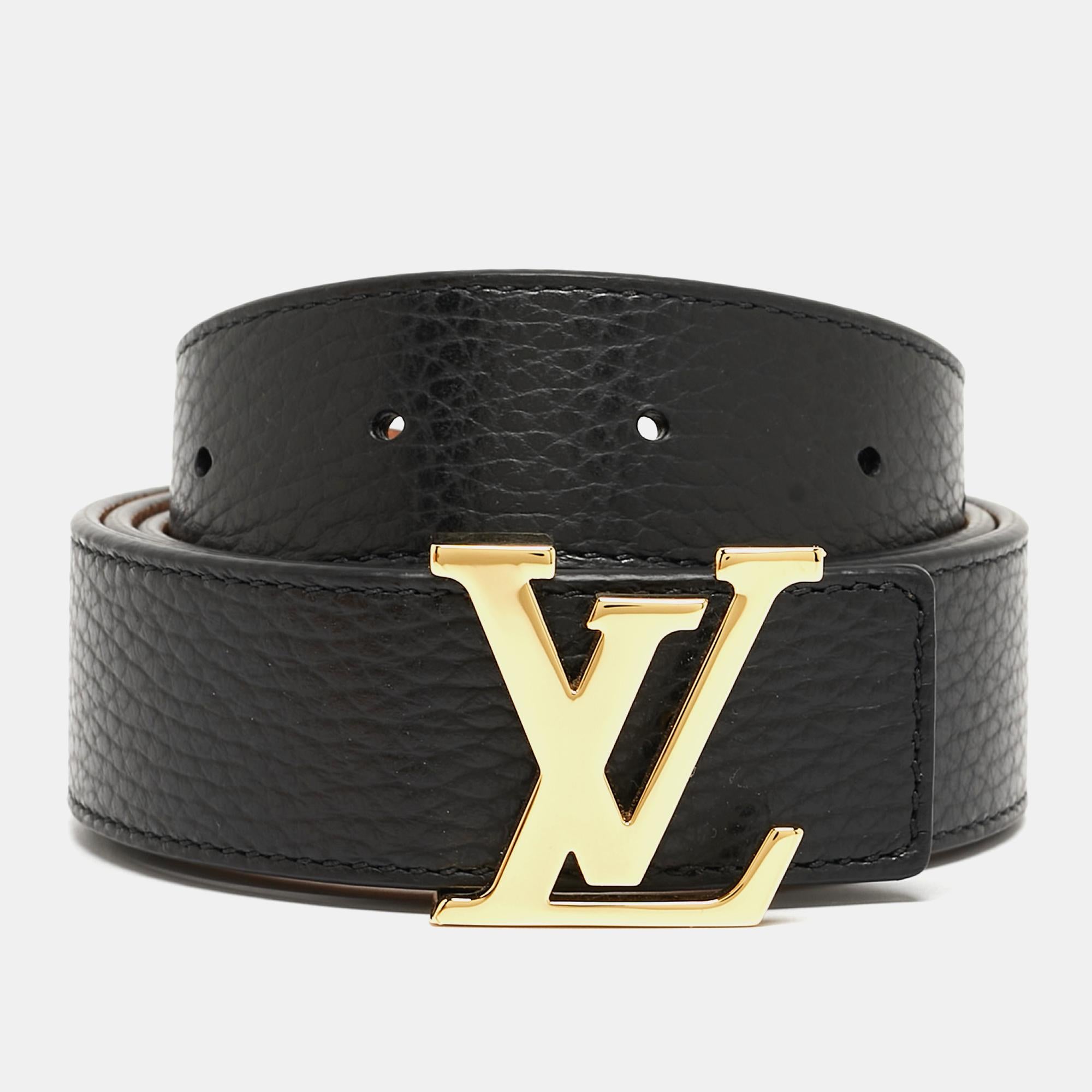 This Louis Vuitton belt has been crafted to a sleek and seamless finish. Made from leather, it features the polished LV logo buckle in gold-tone metal and loopholes for an adjustable fit. Its reversible feature allows you to wear it in black or