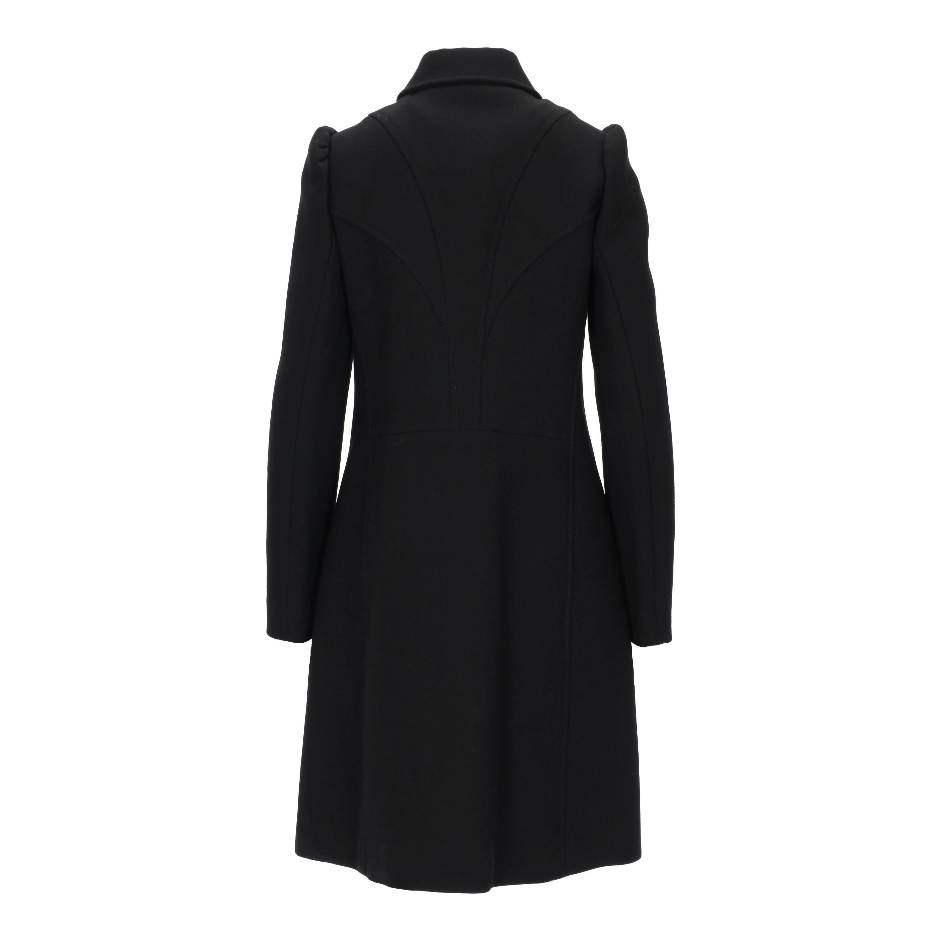 A refined single breasted coat by Louis Vuitton, crafted from 100% wool. It features a streamlined, flared shape with pleats placed strategically and a classic spread collar. The front showcases a concealed button stand with leather covered buttons,