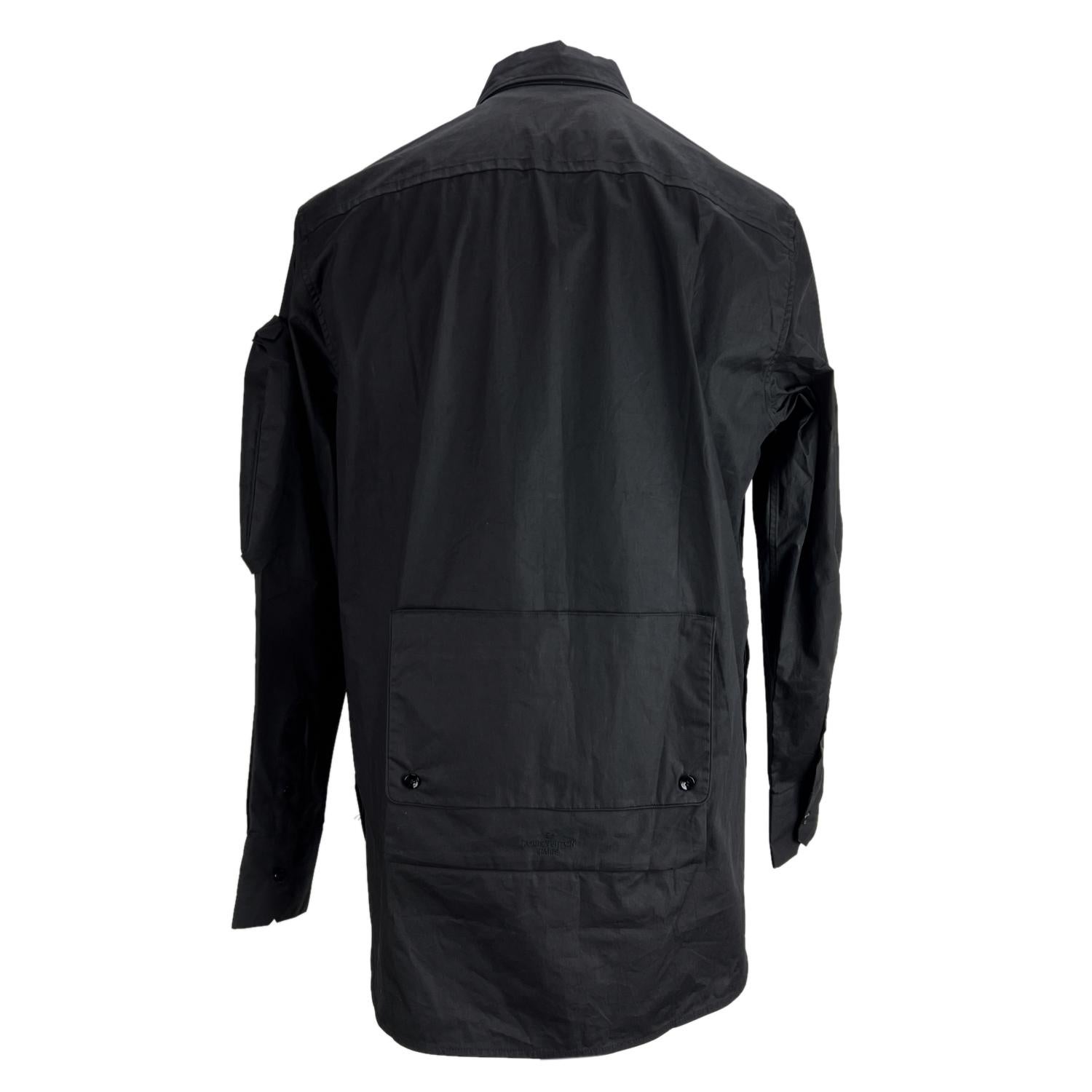 Louis Vuitton black 'Plain Rainbow' men's shirt. Coated cotton. Relaxed fit. Button closure on the front. It features applied pockets on the sleeve and back. Collared neckline. Long sleeve with buttoned cuffs. Embroidered Louis Vuitton signature.