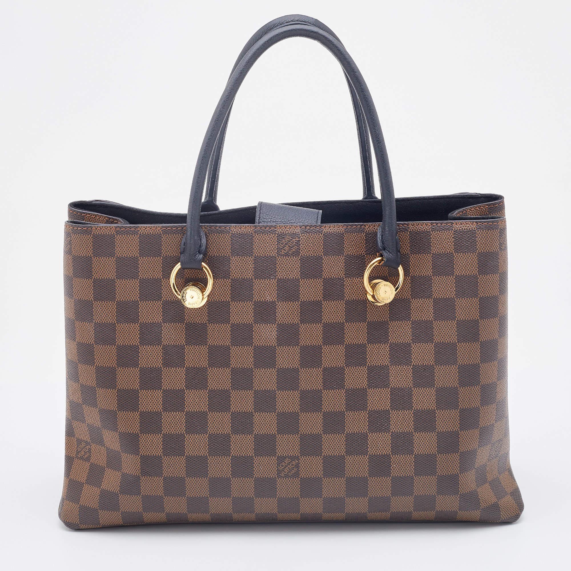Have a finely crafted, timeless creation in your arm with this Louis Vuitton handbag. Known as the LV Riverside, the bag has a sleek shape and a functional quality. It is crafted from Damier Ebene canvas & leather and comes with a large LV logo