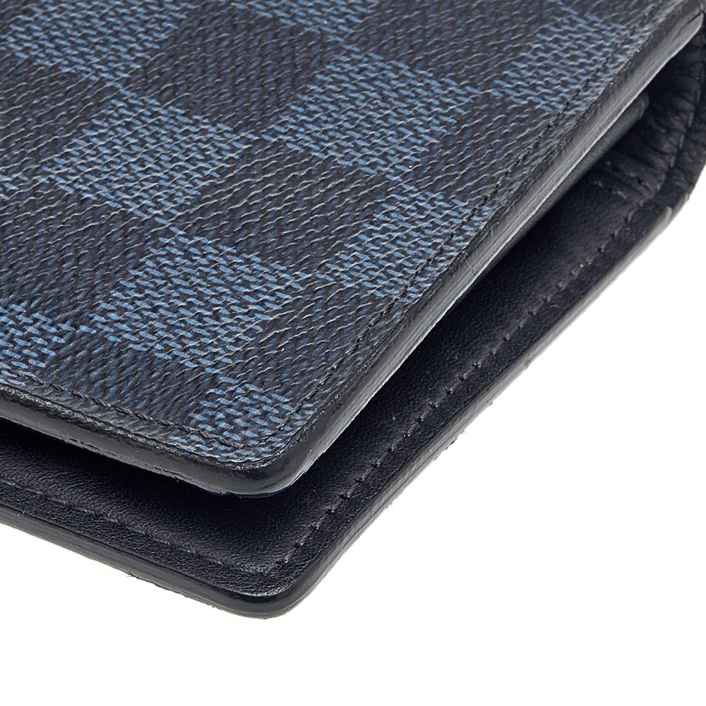 This Brazza wallet from the House of Louis Vuitton is a stylish and functional accessory. It is crafted using black Damier Graphite canvas and flaunts silver-tone hardware. It has a leather-lined interior, which offers multiple storage alternatives.