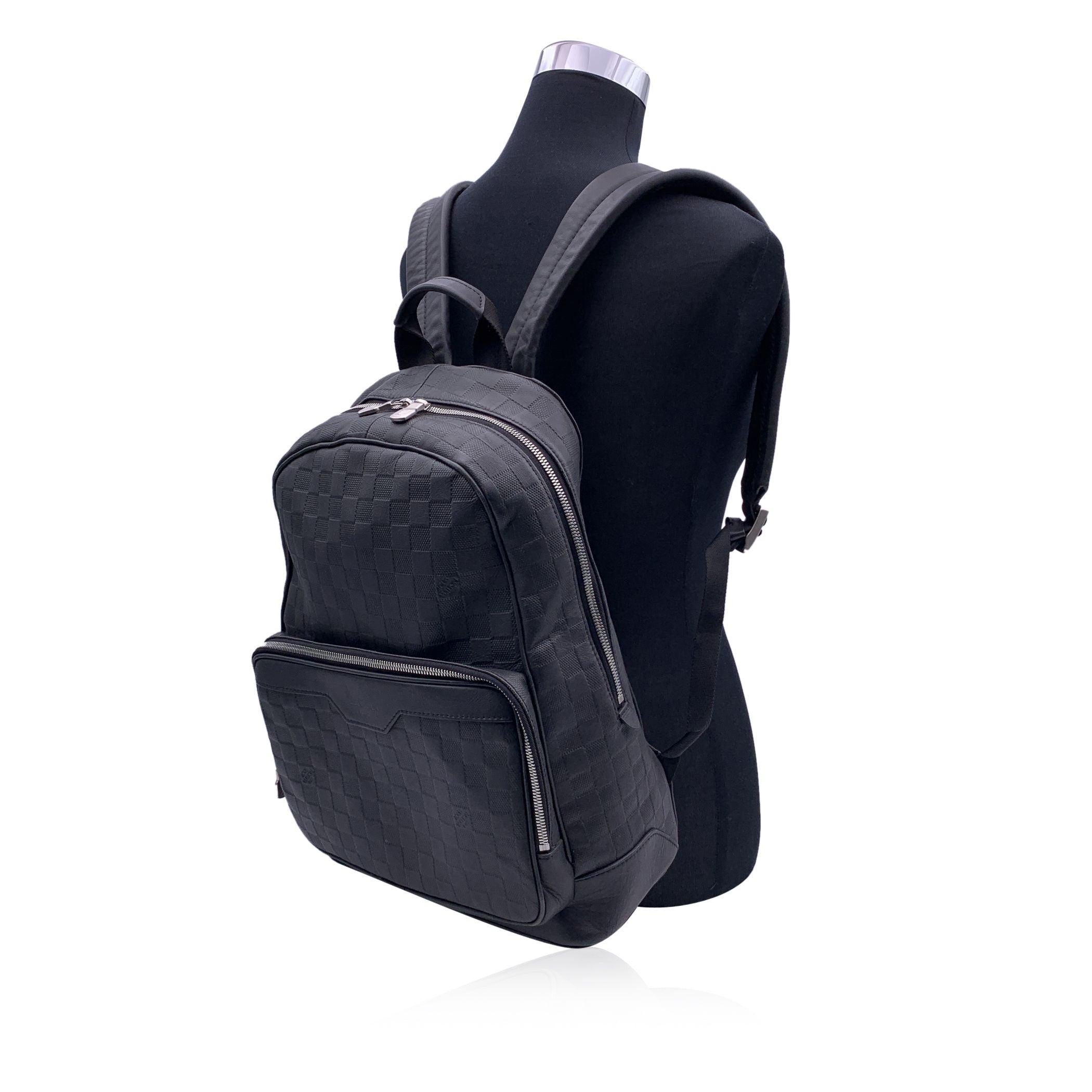 This beautiful Bag will come with a Certificate of Authenticity provided by Entrupy. The certificate will be provided at no further cost Louis Vuitton black Damier Infini Backpack bag. Damier infini leather. Silver metal hardware. Upper zipper
