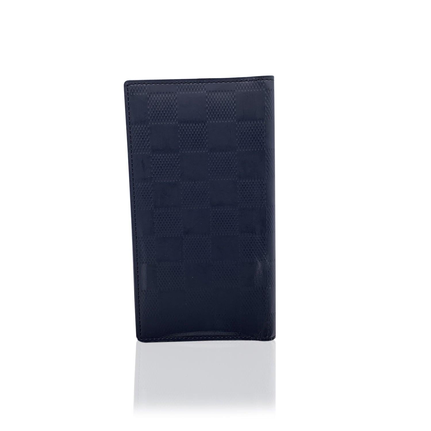 Louis Vuitton Black Damier Infini Vertical Wallet. 2 side pockets and 3 credit card slots inside. Authenticity Serial Number TH0061inside one of the pockets. 'LOUIS VUITTON Paris - made in France' engraved inside. Details MATERIAL: Leather COLOR: