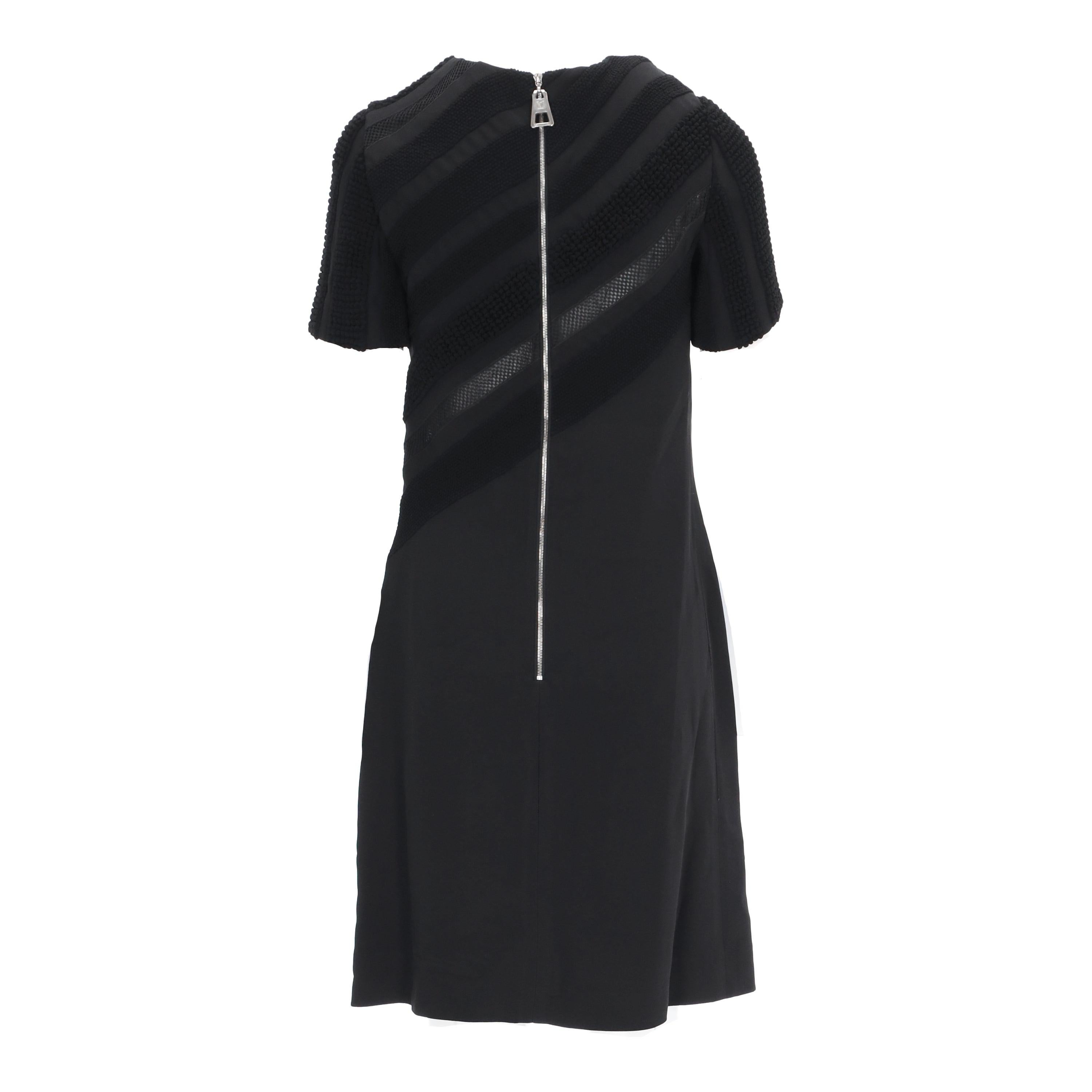 This Louis Vuitton black dress is a modern twist on the classic little black dress. Featuring a short-sleeved silhouette, its versatile black hue is complemented by intricate textured details on the upper for a unique visual texture. Wearable for