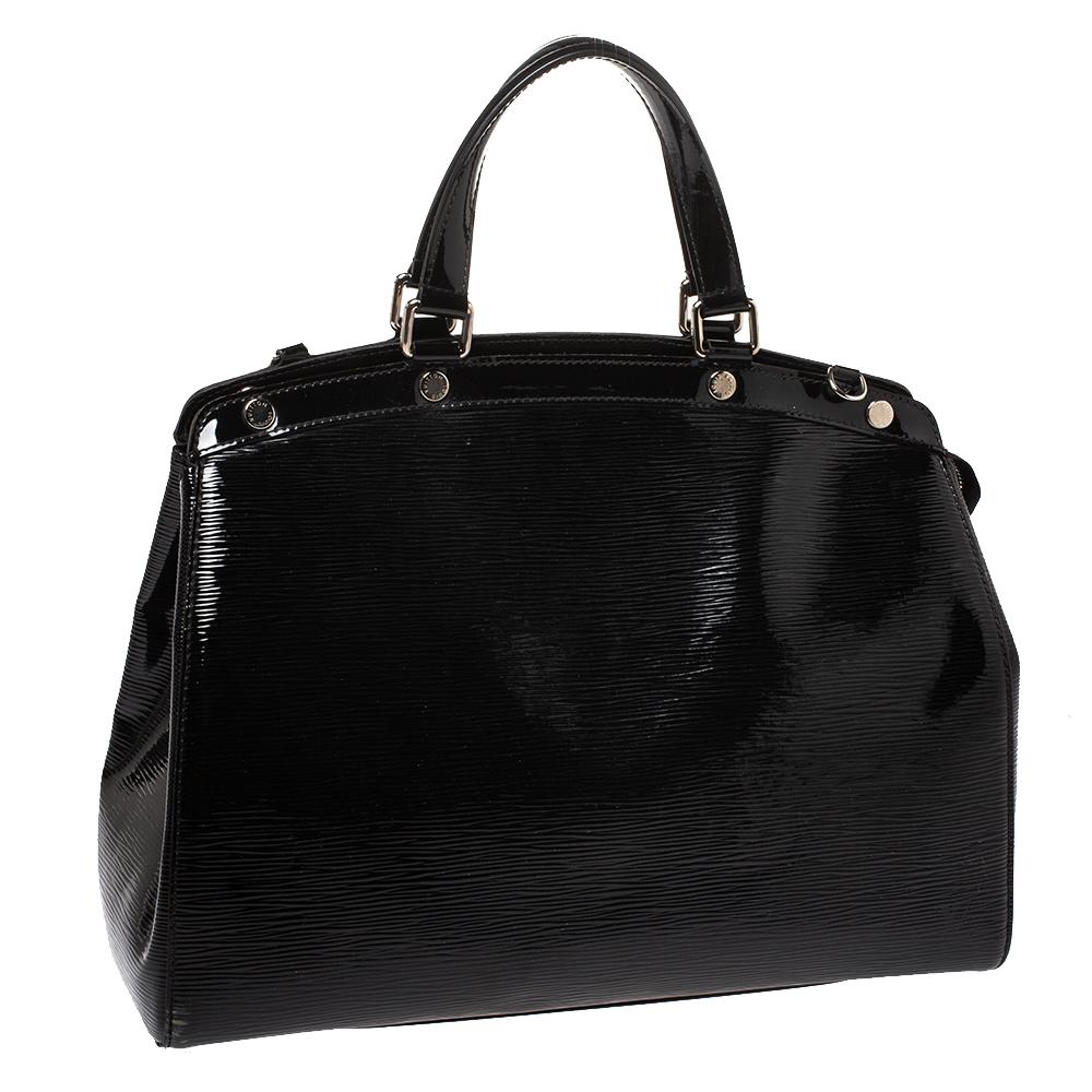 The feminine shape of Louis Vuitton's Brea is inspired by the doctor's bag. Crafted from patent Epi leather in black, the bag has a perfect finish. The fabric interior is spacious and it is secured by a zipper. The bag features double handles,
