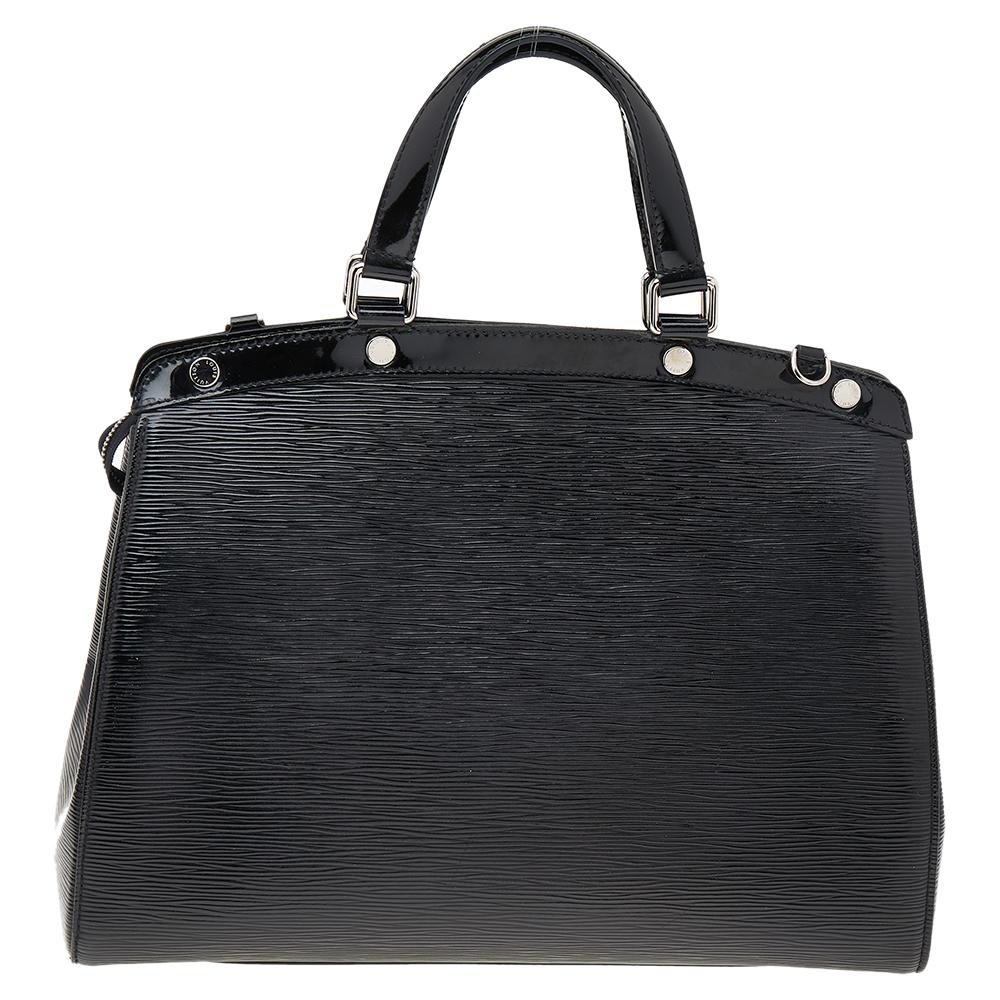 The feminine shape of Louis Vuitton's Brea is inspired by the doctor's bag. Crafted from epi patent leather in black, the bag has a perfect finish. The fabric interior is spacious and it is secured by a zipper. The bag features double handles,