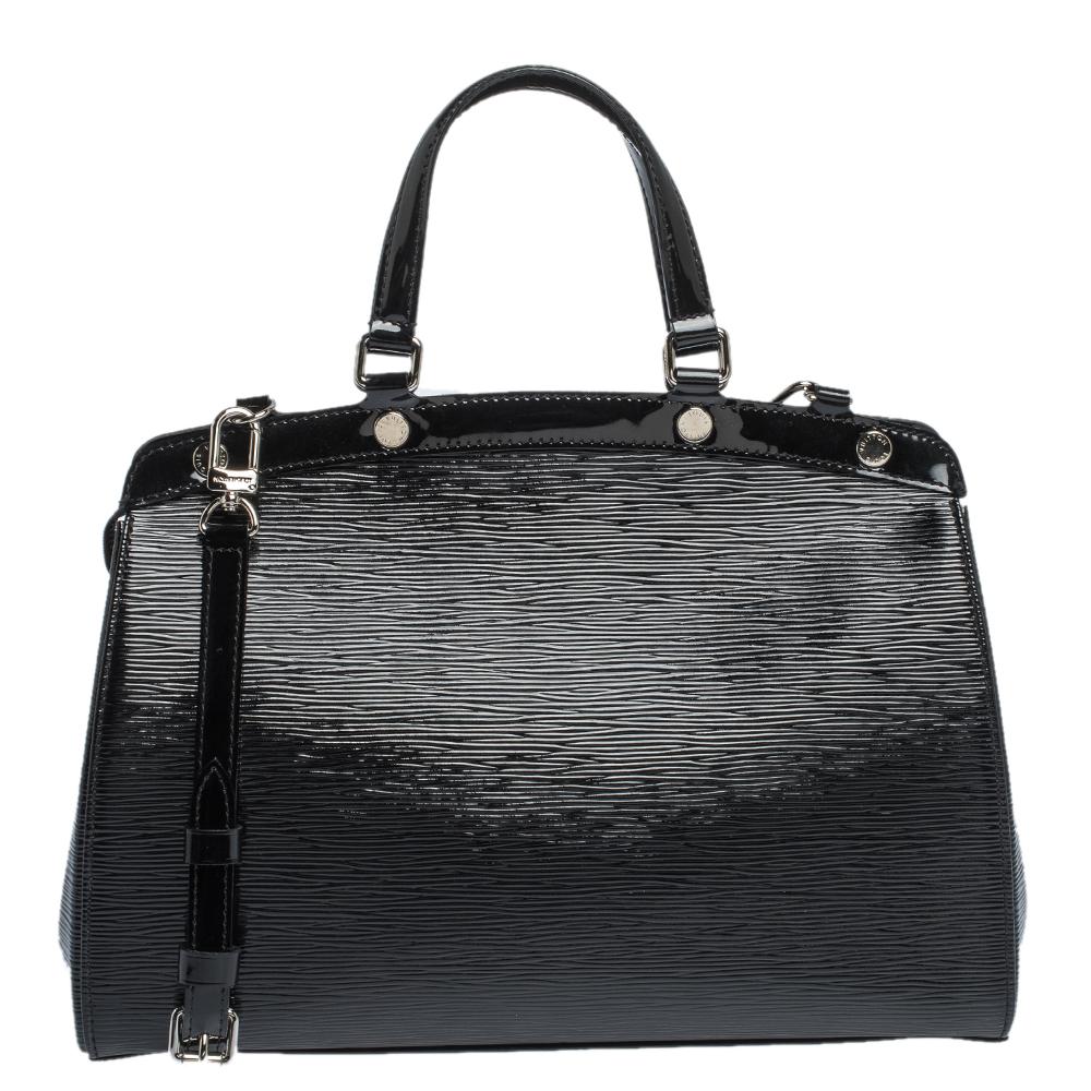 The feminine shape of Louis Vuitton's Brea is inspired by the doctor's bag. Crafted from Electric Epi leather in black, the bag has a perfect finish. The fabric interior is spacious and it is secured by a zipper. The bag features double handles,