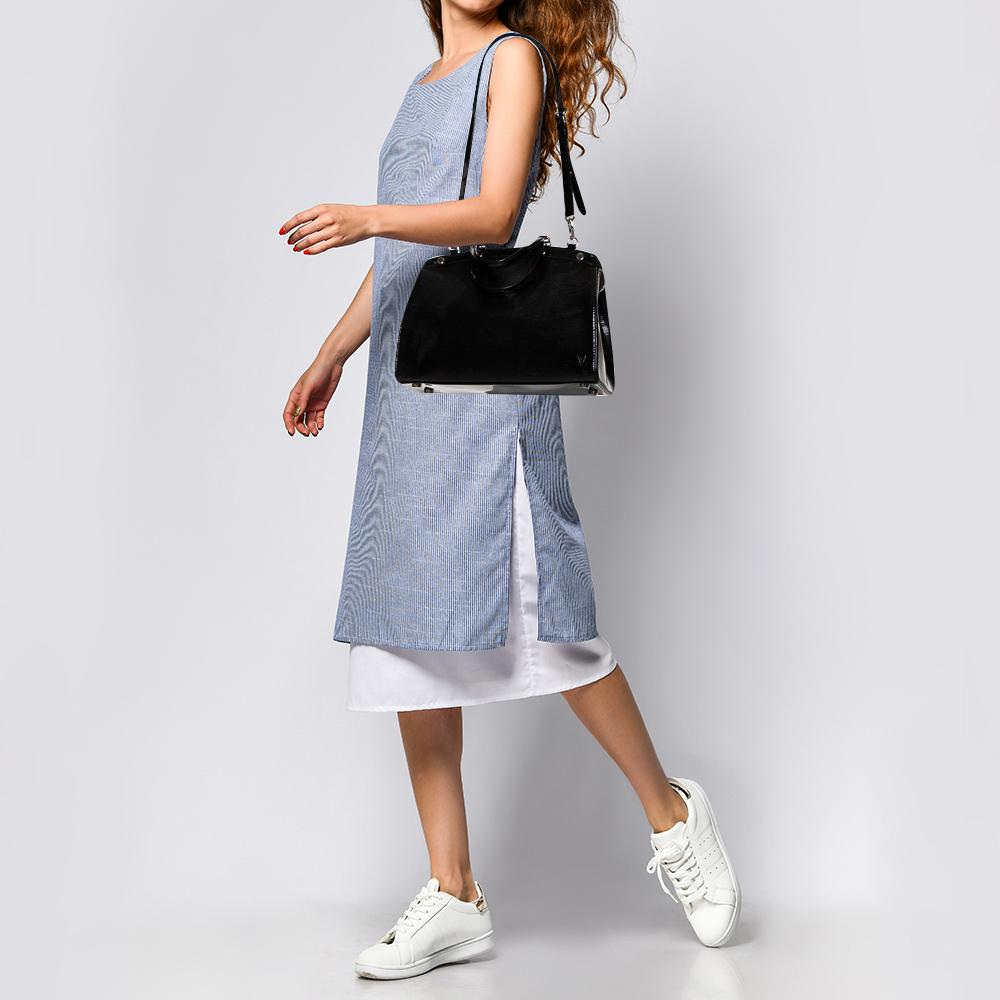 Die feminine Form der Brea von Louis Vuitton ist von der Arzttasche inspiriert. Die Tasche ist aus schwarzem Electric Epi eather gefertigt und hat ein perfektes Finish. Der Innenraum aus Stoff ist geräumig und wird mit einem Reißverschluss