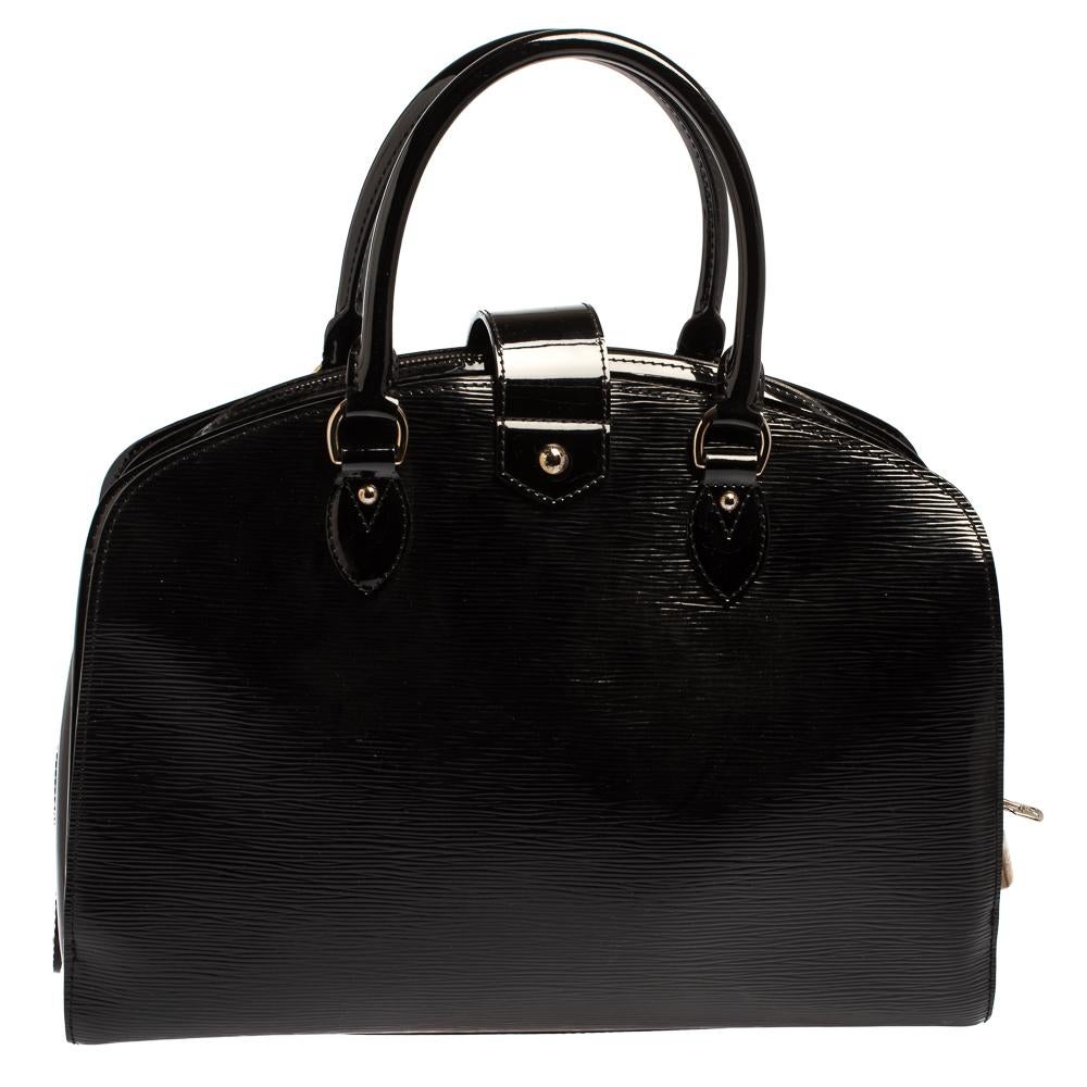 Pont Neuf is a notable descendant of Louis Vuitton’s classic 'Steamer'. Rendered in sturdy silhouette, this bag is crafted from black Epi patent leather, and features top rolled handles with a strap that holds a push lock. It is further secured by a