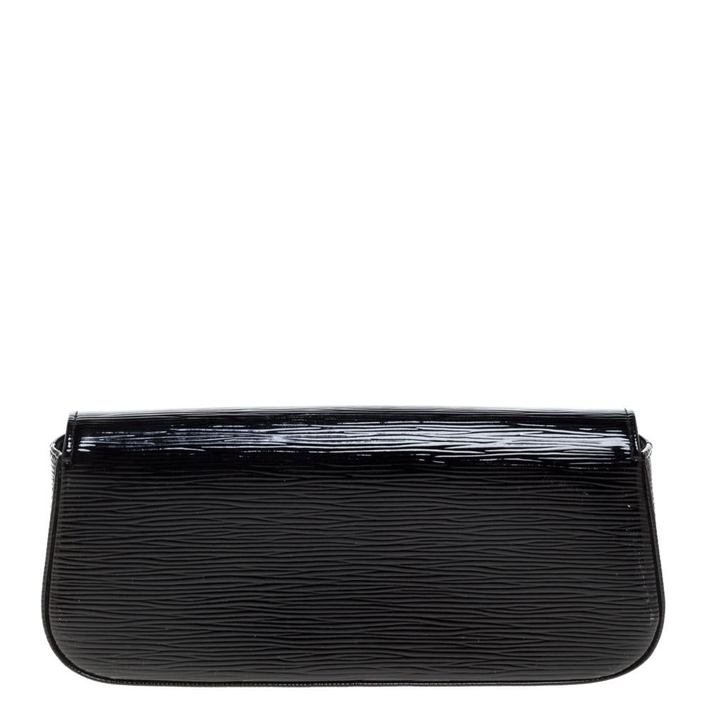 Well-crafted and overflowing with style this Sobe clutch is from Louis Vuitton. It has an epi patent leather exterior, a fabric interior, and a large LV adorned on the flap. This creation will lift all your gowns and elegant