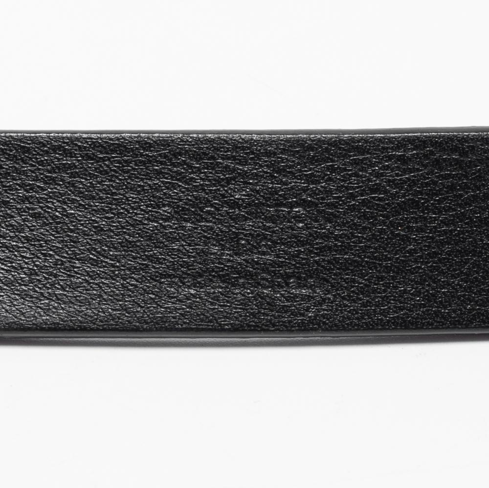 This Initiales belt from Louis Vuitton is recognizable at first glance. The embossed leather strap has a gold-tone metal buckle in the form of an enlarged LV symbol. It is perfect to adorn your waist and for making a style statement.

Includes: