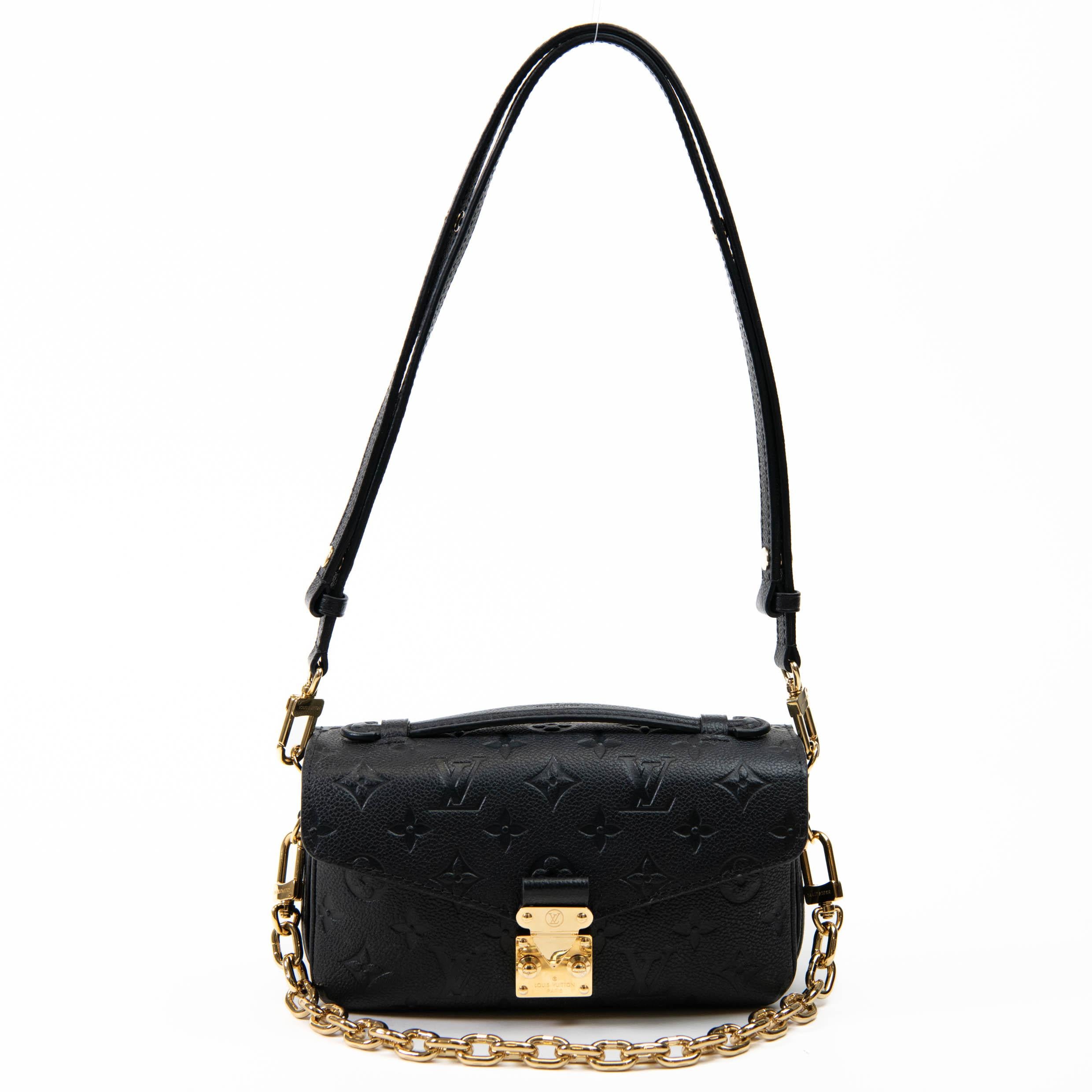 100% Authentic 

 This chic handbag is finely crafted of Louis Vuitton monogram Empreinte leather in black. The bag features a leather strap handle, gold hardware, and a zippered pocket on the back. The envelope-style crossover flap opens with a