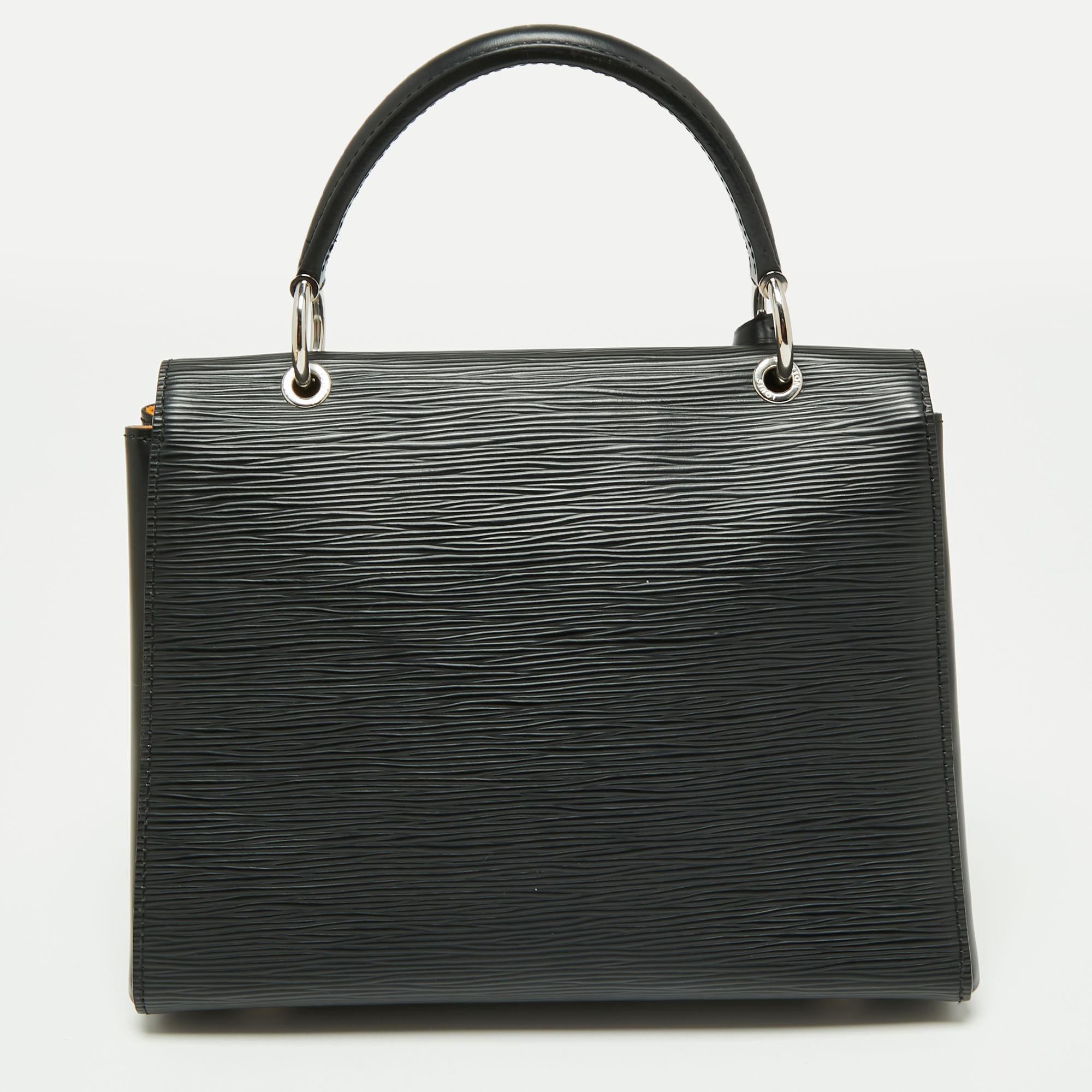 With a perfect balance of chic style and minimalism, this Grenelle bag from the house of Louis Vuitton is an ideal pick for everyday use. It is created using black Epi leather, with a logo accent placed on the front. It features a top handle,