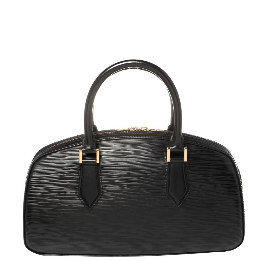 Add some magic to your everyday attire with this classy black Jasmin bag crafted from Epi leather and featuring an Alcantara interior, to give you durability along with supreme style. This Louis Vuitton piece is designed with two top handles and a