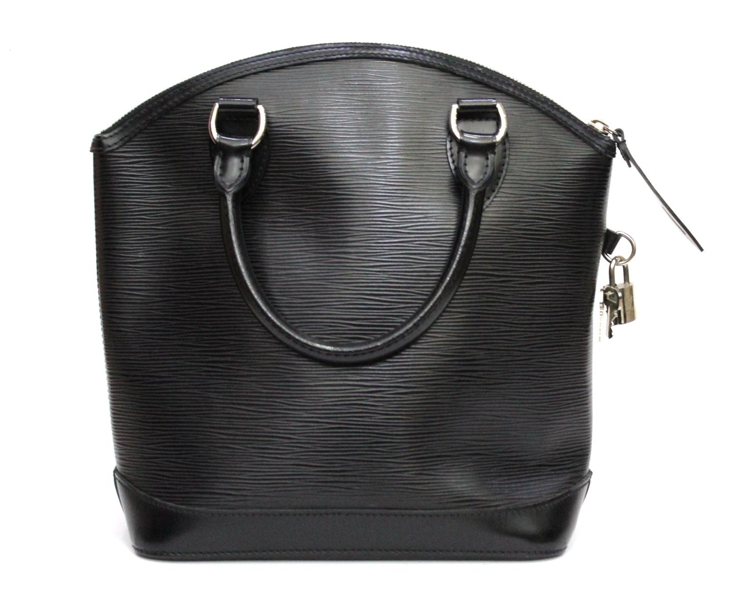 This super-chic tote is beautifully crafted of Louis Vuitton signature textured epi leather. The bag features smooth rolled leather top handles, trim, a base, and polished silver hardware including a top zipper. This opens to a fabric interior. This