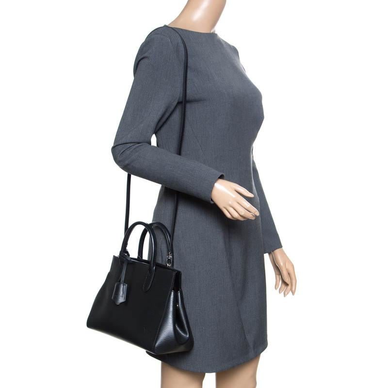 This stylish Louis Vuitton creation was introduced in the Pre-Fall 2014 collection. This Marly bag is crafted from classic Epi leather and the frame top has a magnetic closure that opens to an Alcantara lined interior. It features a shoulder strap,