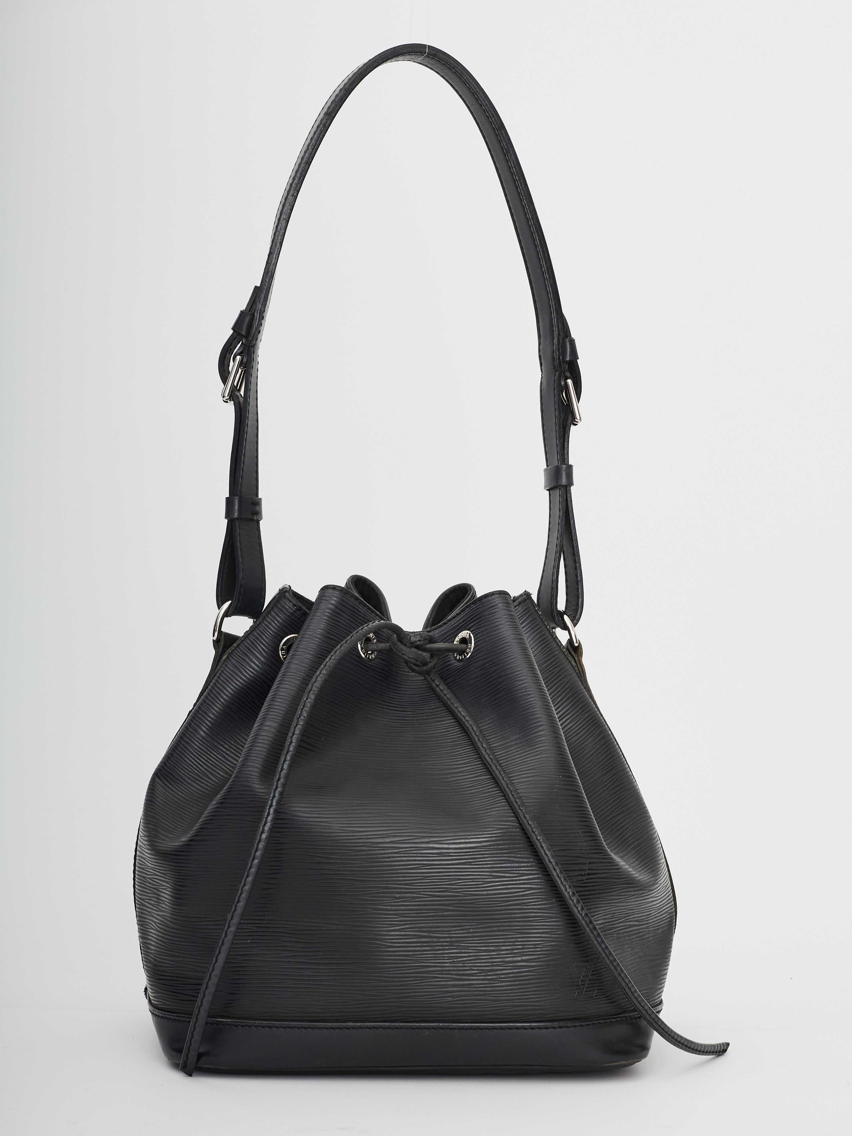 This bucket bag is made of Louis Vuitton signature textured epi leather. The bag features a black leather shoulder strap with polished brass hardware and a cinch strap with brass eyelets. This opens to a black microfiber interior.

COLOR: