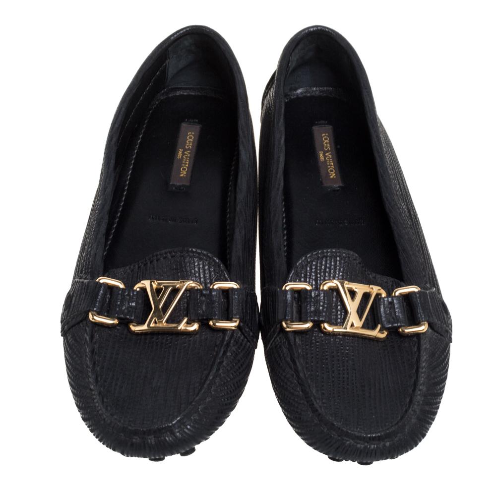 Louis Vuitton's loafers are loved by men and women worldwide as they are perfect for making a fashion statement. These black loafers are crafted from Epi leather into a chic design. They flaunt round toes, LV motifs on the vamps, comfortable
