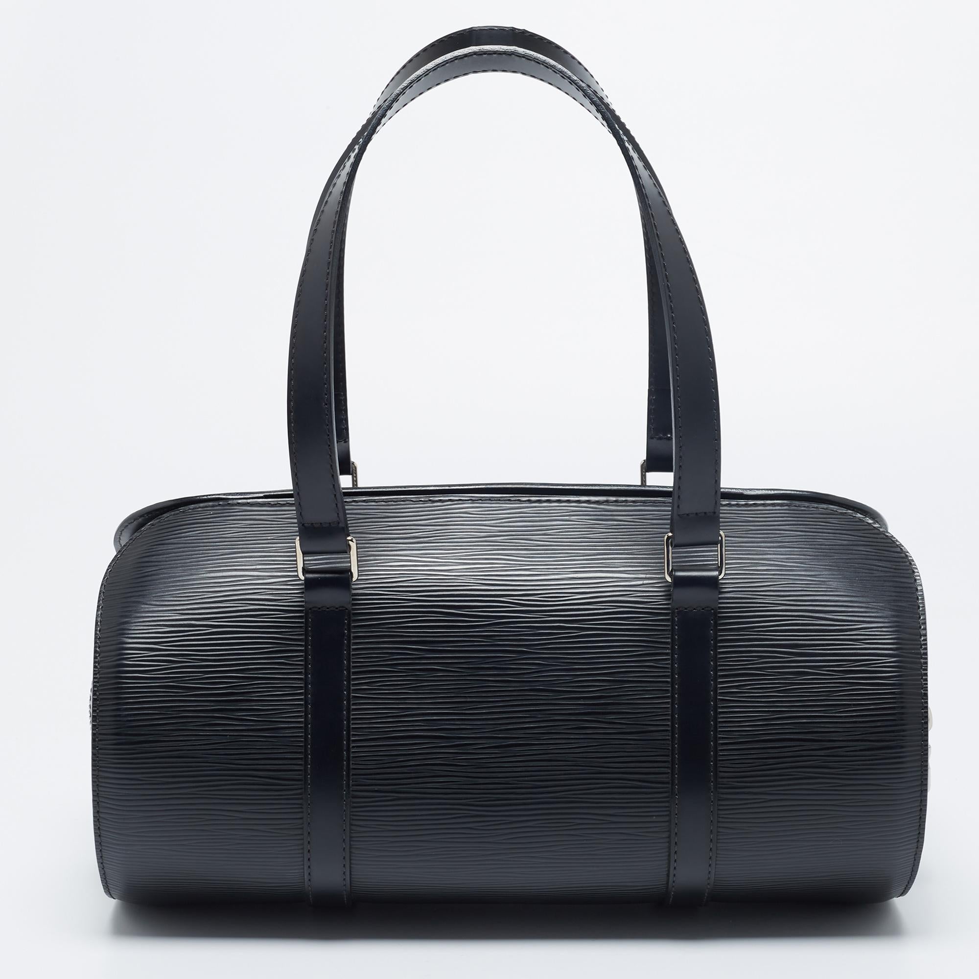 Another classic creation from the house of Louis Vuitton is this beautiful Papillon 30 bag. It is made from black Epi leather into a structured silhouette. It has dual handles, silver-toned hardware, and an Alcantara-lined interior. Chic and