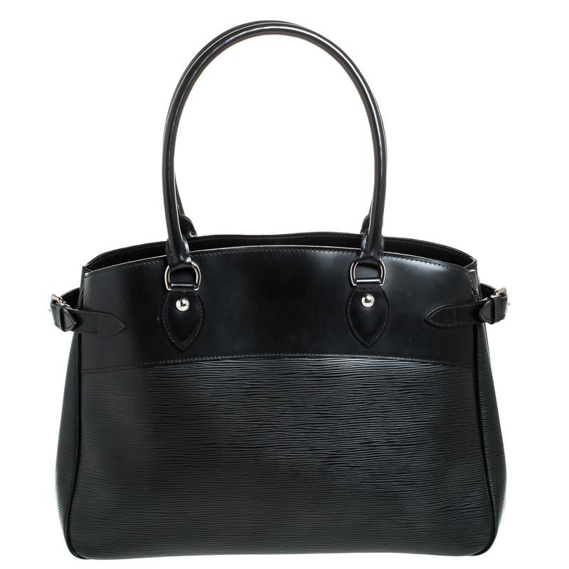 Accent your work outfit with this Louis Vuitton Passy GM bag. It is made from LV's signature epi leather in a black color and features side buckle detailing, rolled leather handles and a stylish structure. The bag comes with a fabric-lined interior