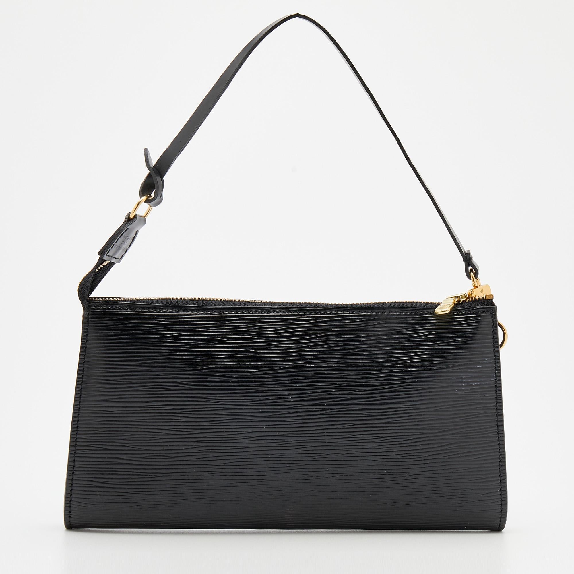 Featuring a black epi leather exterior, this adorable LV pochette is accented with gold-tone hardware. It is finished with a single handle and a zip closure that opens to a well-sized interior. Get this sleek creation today!