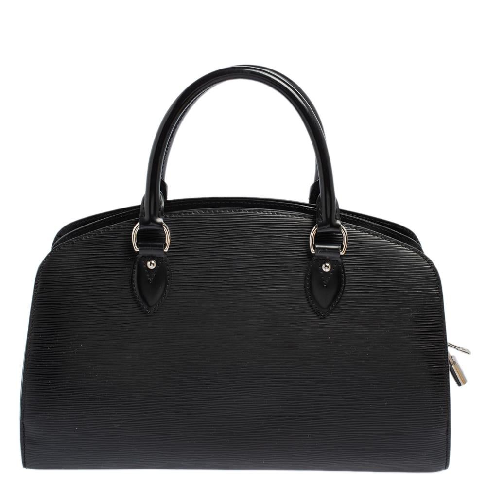 Pont Neuf is a notable descendant of Louis Vuitton’s classic 'Steamer'. Rendered in sturdy silhouette, this bag is crafted from black Epi leather, and features top rolled handles and a structured silhouette. It is further secured by a top zip that
