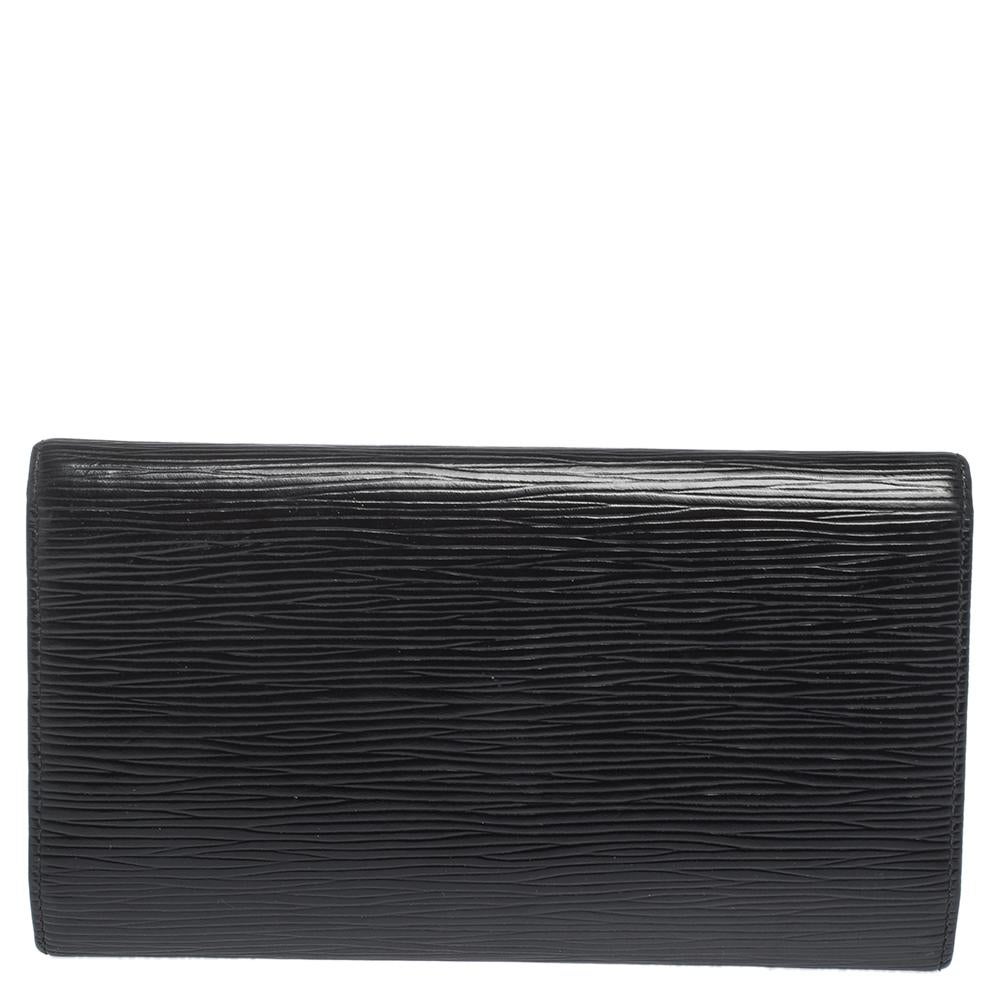 Functional luxury from Louis Vuitton, this Porte Tresor wallet is made from highly durable Epi leather. Its smart exterior has a fold-over structure and features a snap button closure. Neatly arranged storage including a series of card slots and an