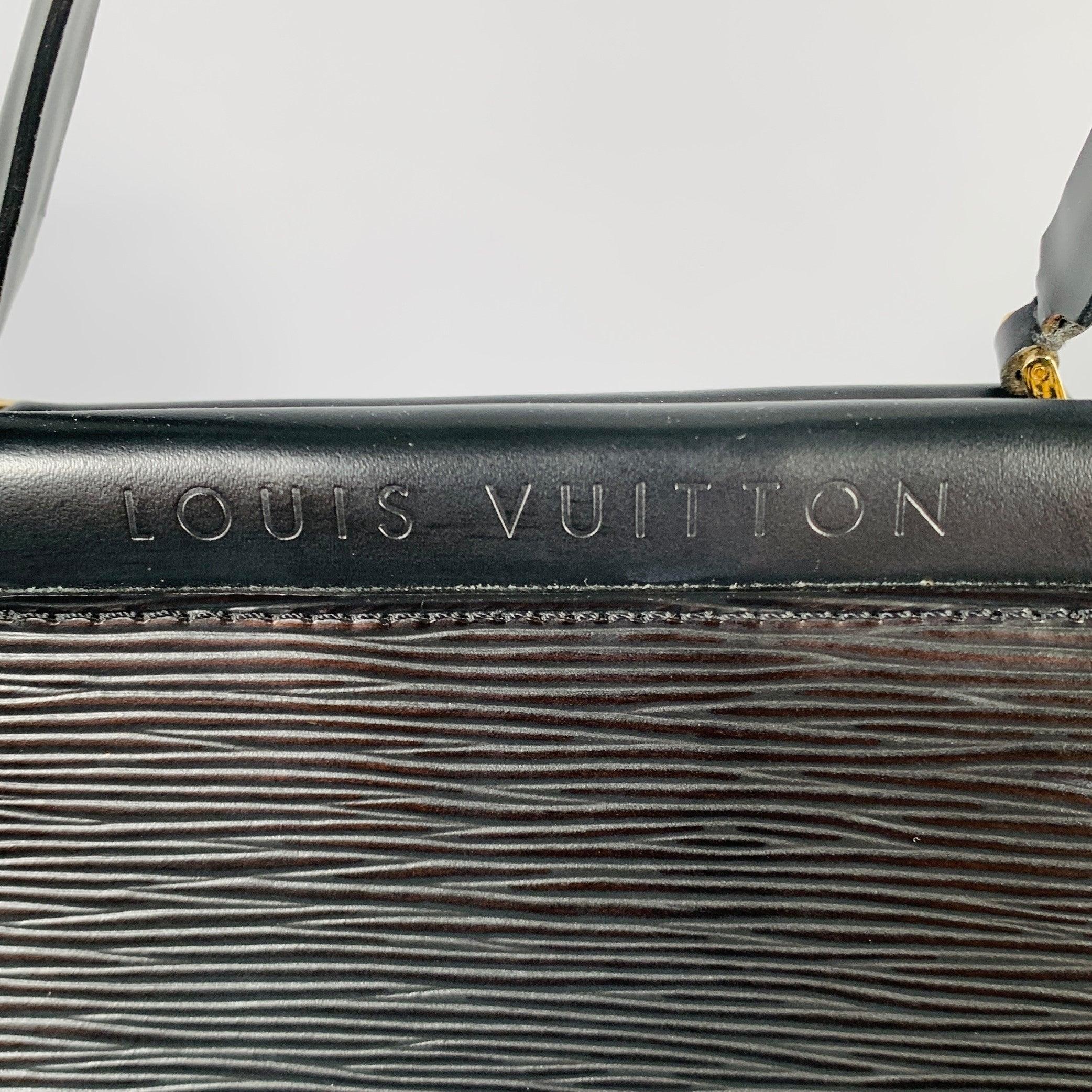 LOUIS VUITTON handbag
in a durable black epi leather featuring top handles, gold tone hardware, and zip-up closure. Made in France.Excellent Pre-Owned Condition. 

Marked:   FL0091 

Measurements: 
  Length: 8.5 inches  Width: 3.25 inches  Height: