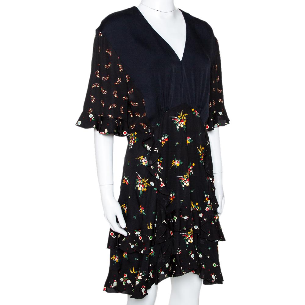 Effortlessly stylish and playful, this dress hails from the house of Louis Vuitton. Crafted from a silk blend, this luxurious crepe dress carries a black hue and a floral print that adds a touch of femininity. It has ruffle detailing, a v-neck, zip