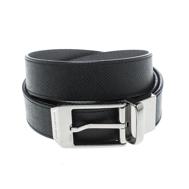 A classic add-on to your collection of belts, this Louis Vuitton Reversible belt is crafted from Taiga leather. This sleek piece is reversible, with a black shade on one side and grey on the other. It is completed with a silver-tone buckle and a