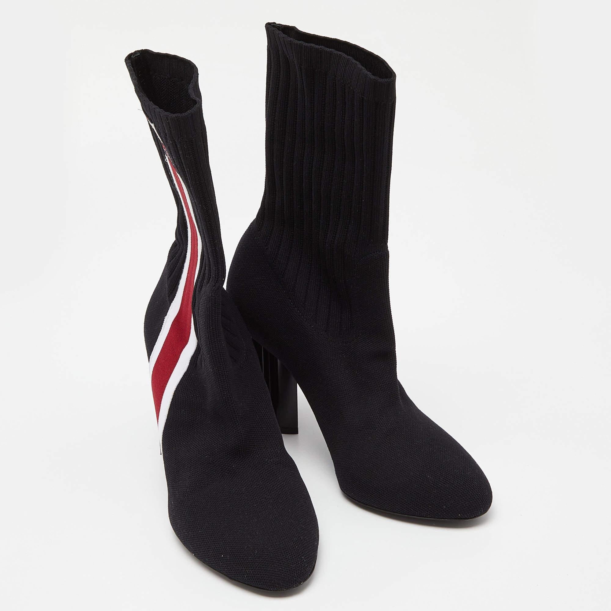 Crafted from knit fabric in a sock design, these Louis Vuitton black boots will help you make a memorable fashion statement. They come with covered toes and heels that are carved as a Monogram flower. The ankle-length boots are finished with