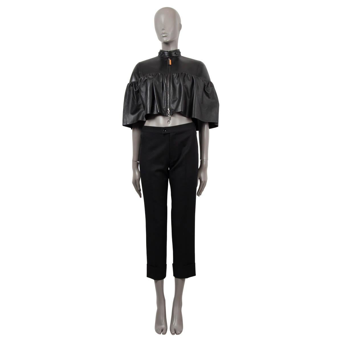 100% authentic Louis Vuitton bolero jacket in black subtle lambskin leather (100%) with gathered lower half that adds a feminine couture touch to the smooth biker look on the top. Closes with a zipper on the front and is lined in silk (100%). Has