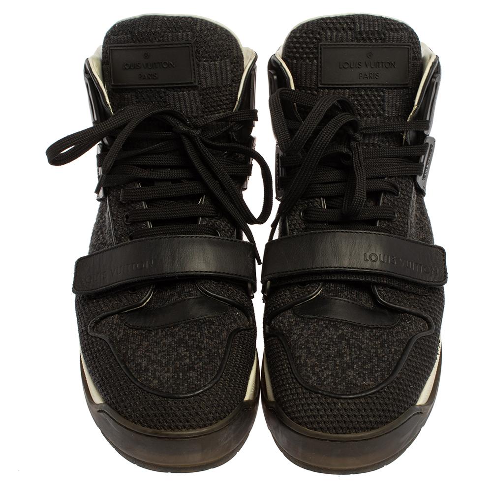 Pull off a dapper casual look in this pair of sneakers from Louis Vuitton. The sneakers have been crafted from black-hued leather & mesh and styled with a high top, a lace-up vamp, round toe, and the brand's logo on the velcro strap, tongues and