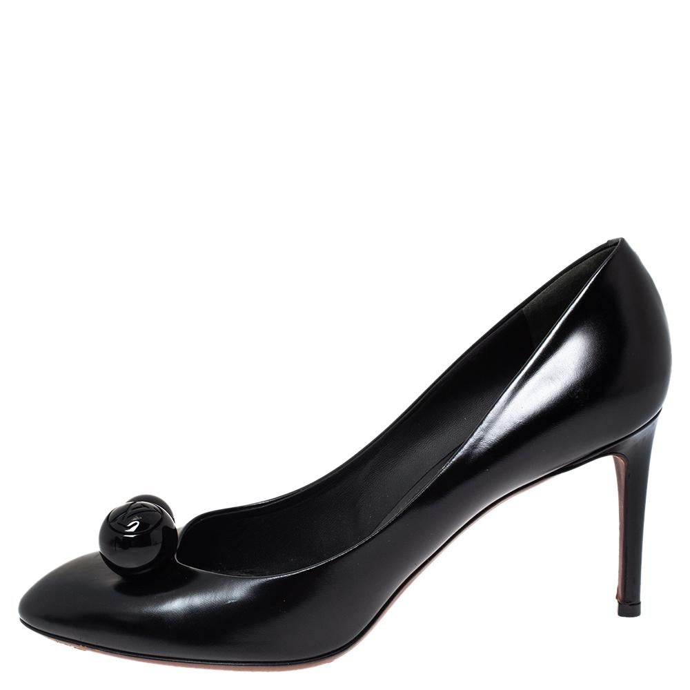 These lovely pumps from Louis Vuitton are an ideal choice as they are stylish and comfortable. The classic pumps are made of black leather and designed with round embellishments on the vamps. This delicate pair is perfect for parties and work. They