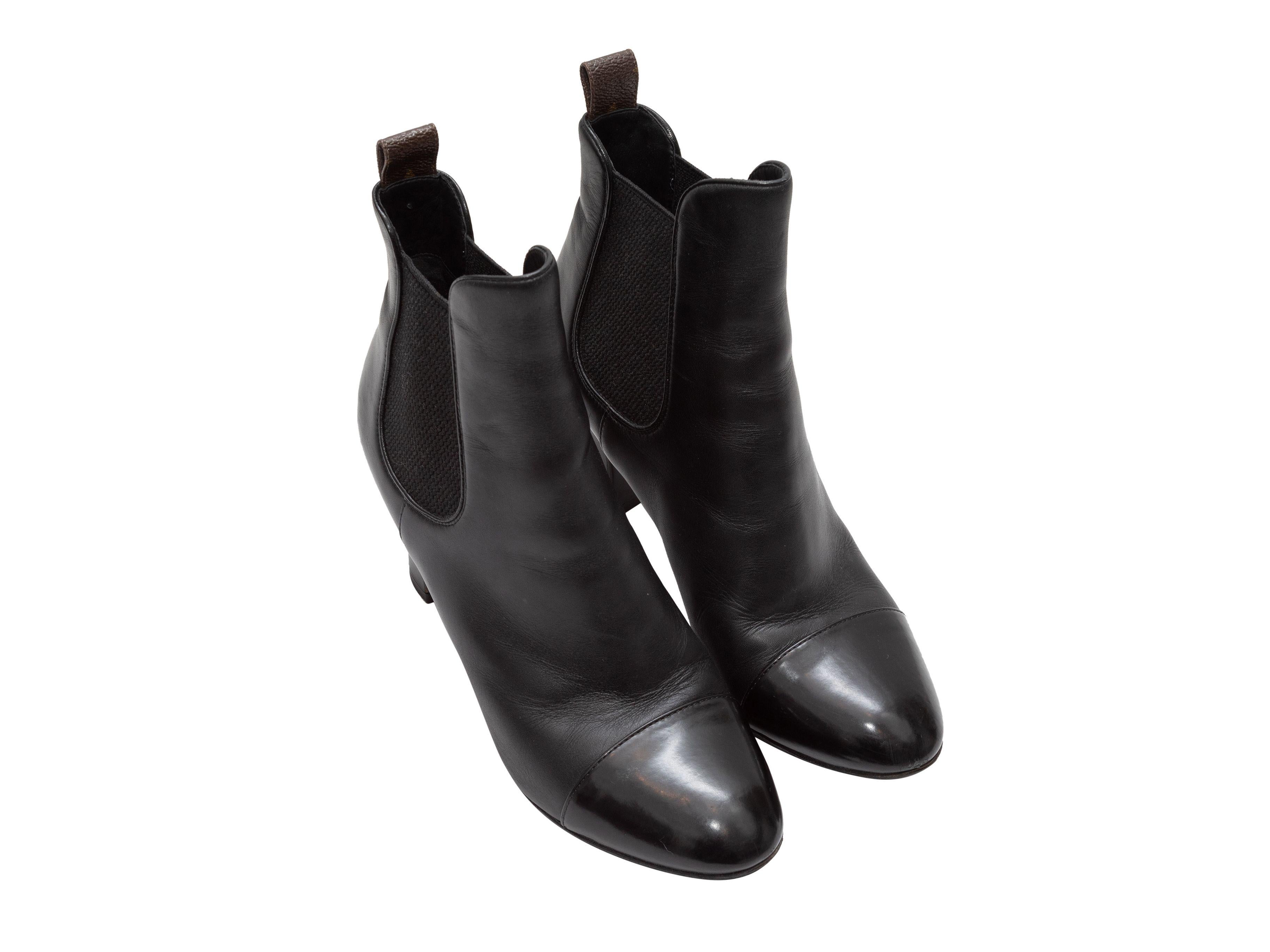 Product Details: Black leather cap-toe ankle boots by Louis Vuitton. Pull-on style. Elasticized gores at sides. 5