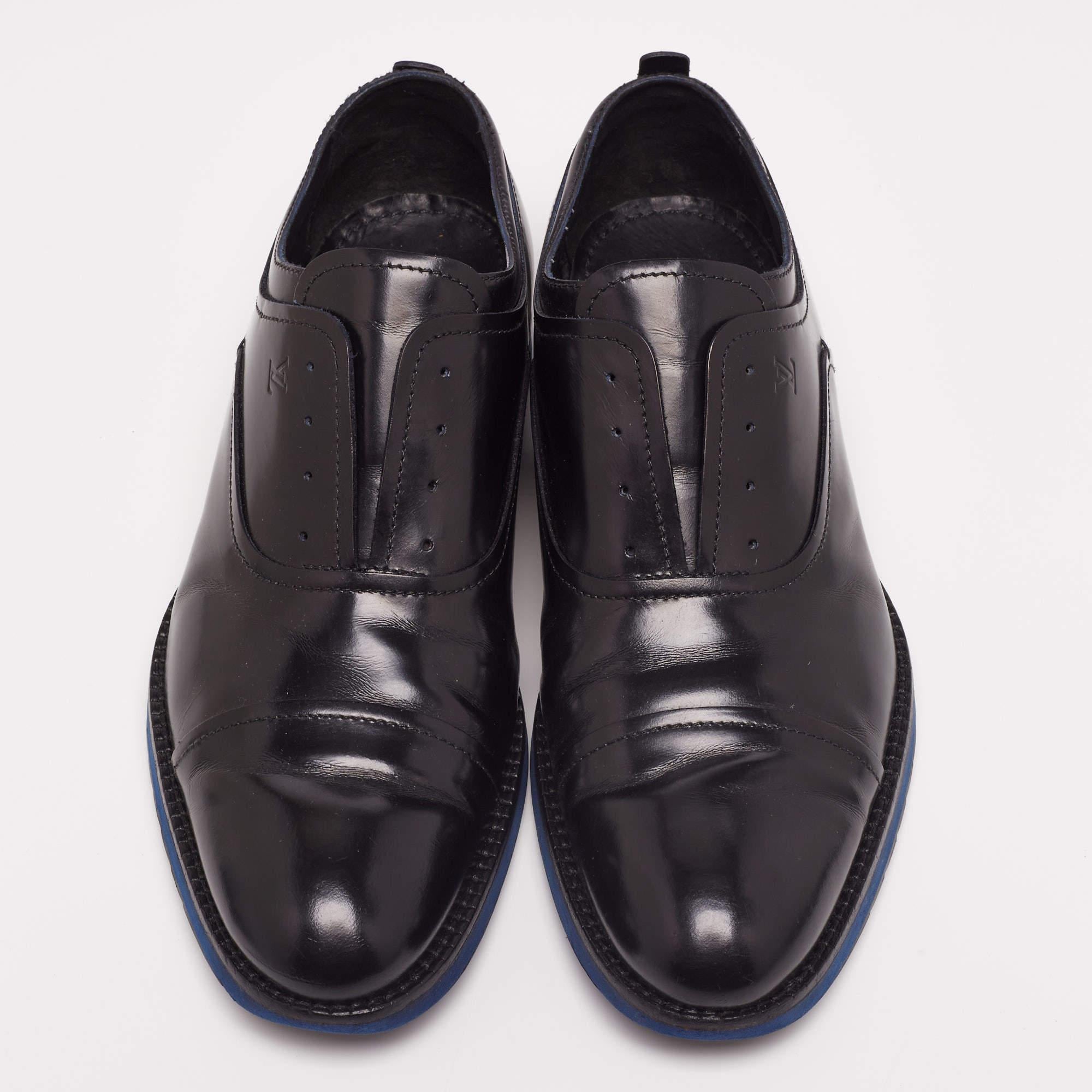 These shoes by Louis Vuitton are notable for their sleek and understated design. Crafted from black leather, they feature cap toes. They are finished with tough outsoles for suppleness and resistance to slips and wear.

