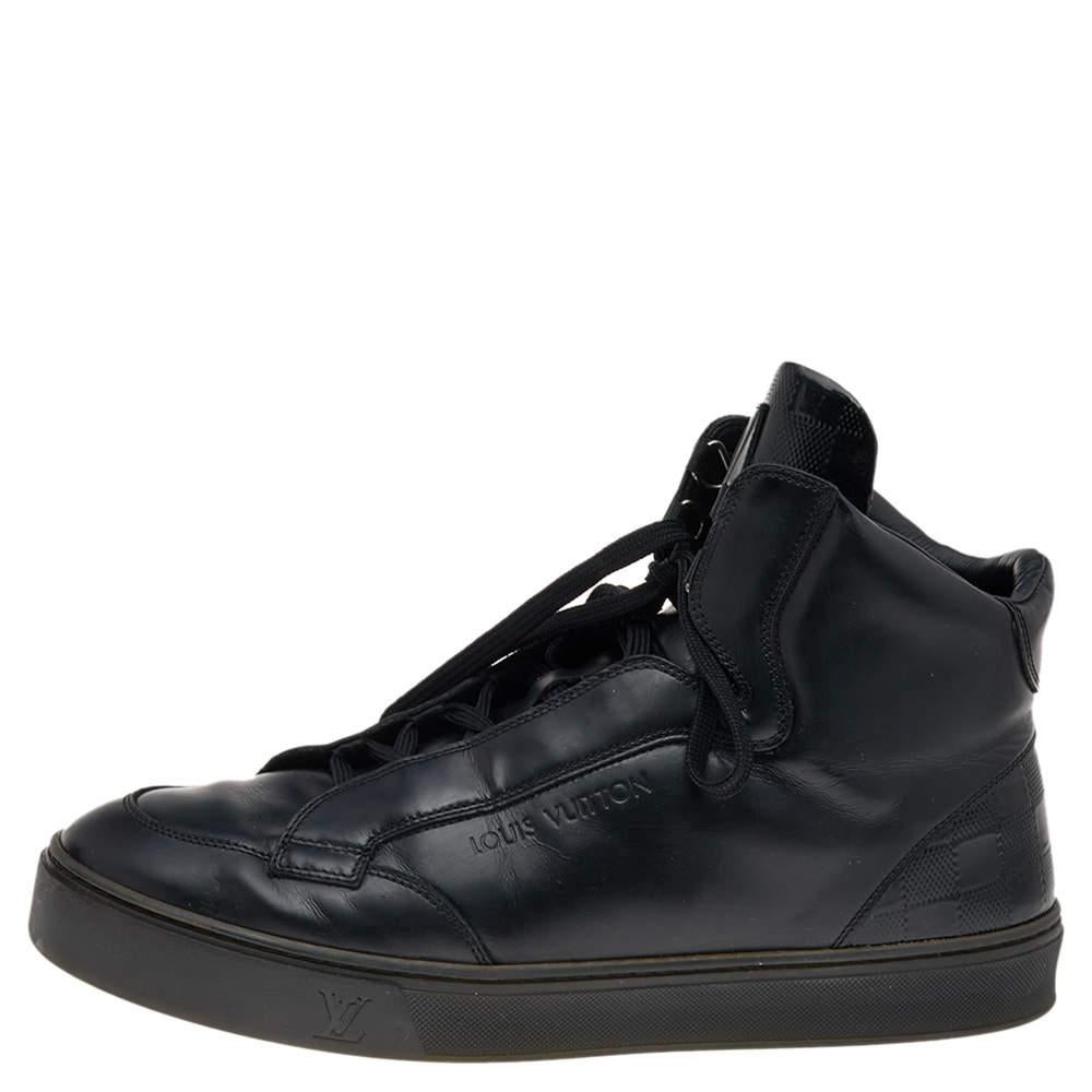 Pull off a dapper casual look in this pair of sneakers from Louis Vuitton. The sneakers have been crafted from black-hued leather and patent leather and styled with Damier panels, a lace-up vamp, round toe, and the brand's logo on the sides &