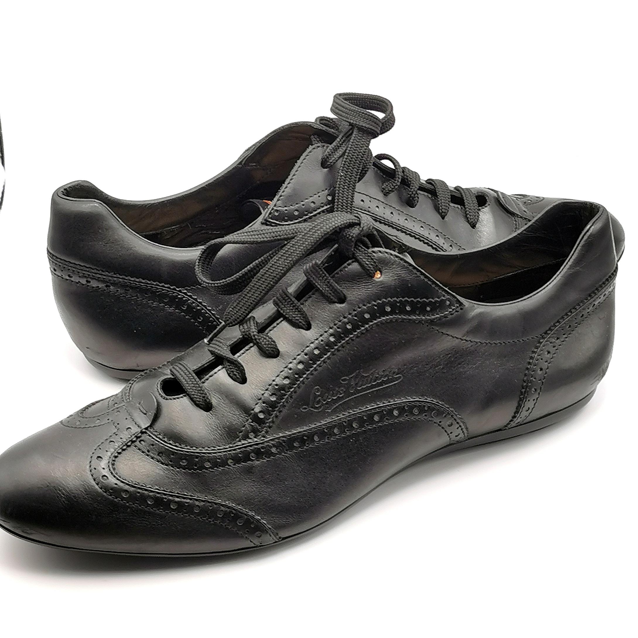 A super stylish pair of Louis Vuitton black leather lace up brogue style sneakers. 

These are the perfect blend of comfort and style with a smart black leather brogue style with Louis Vuitton embossed logo and punch out detailing. 

The tongue